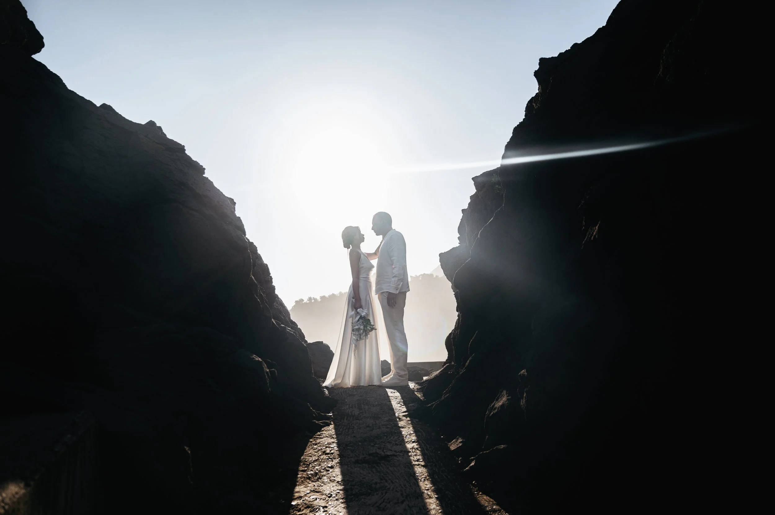 bride and groom posing between the cliffs in madeira elopement shoot