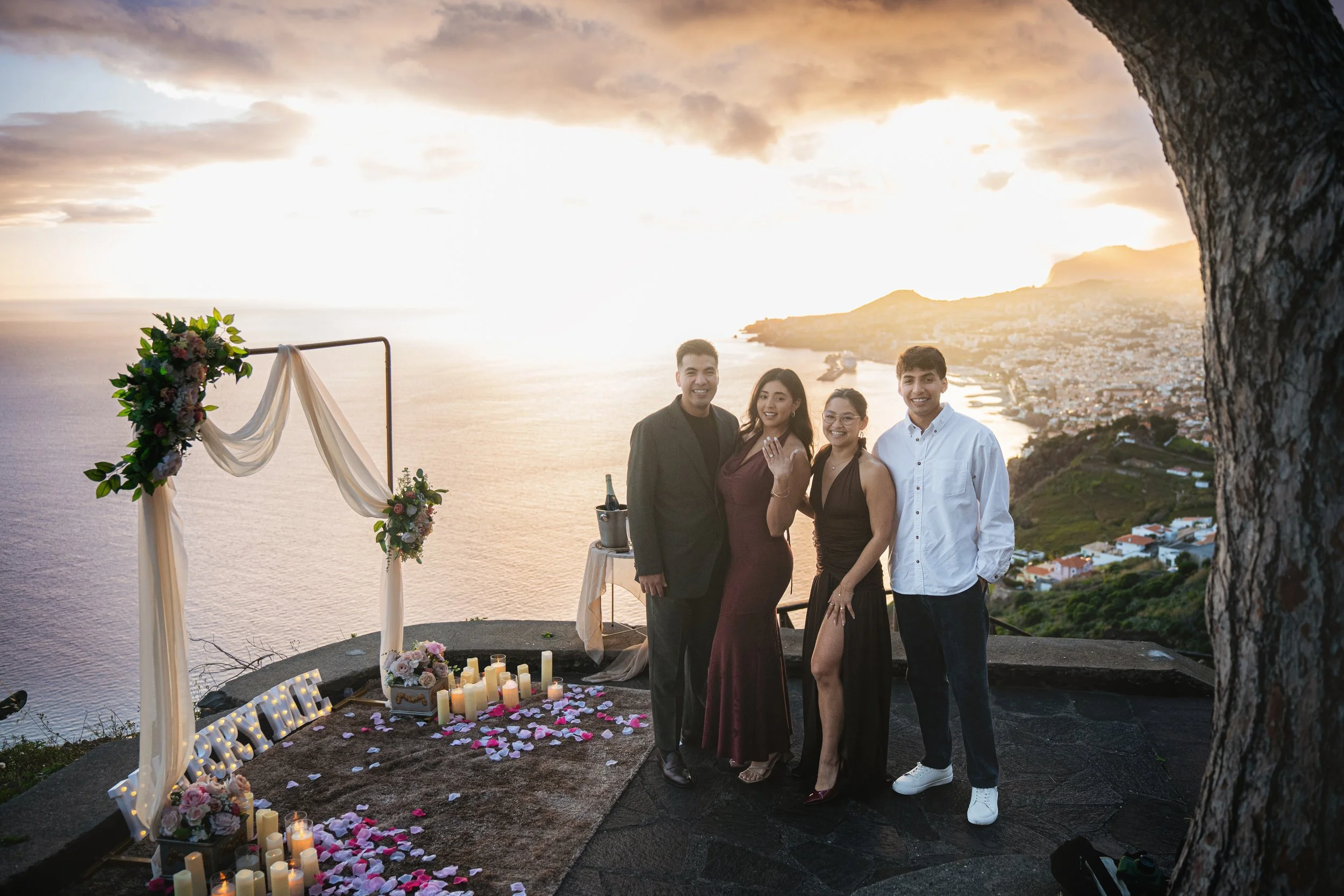family and friends celebrating successfully planned proposal in madeira