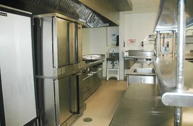 Commercial kitchen with stainless steel appliances and counters.