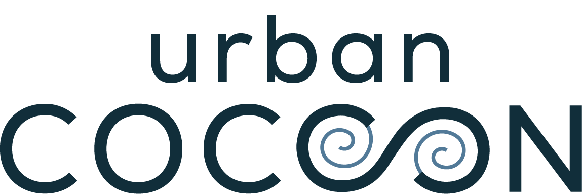The image features a stylized typographic design with the word 'urban' written above the word 'cocktail.' The text is in shades of dark blue and gray, with some swirling decorative elements integrated into the design.