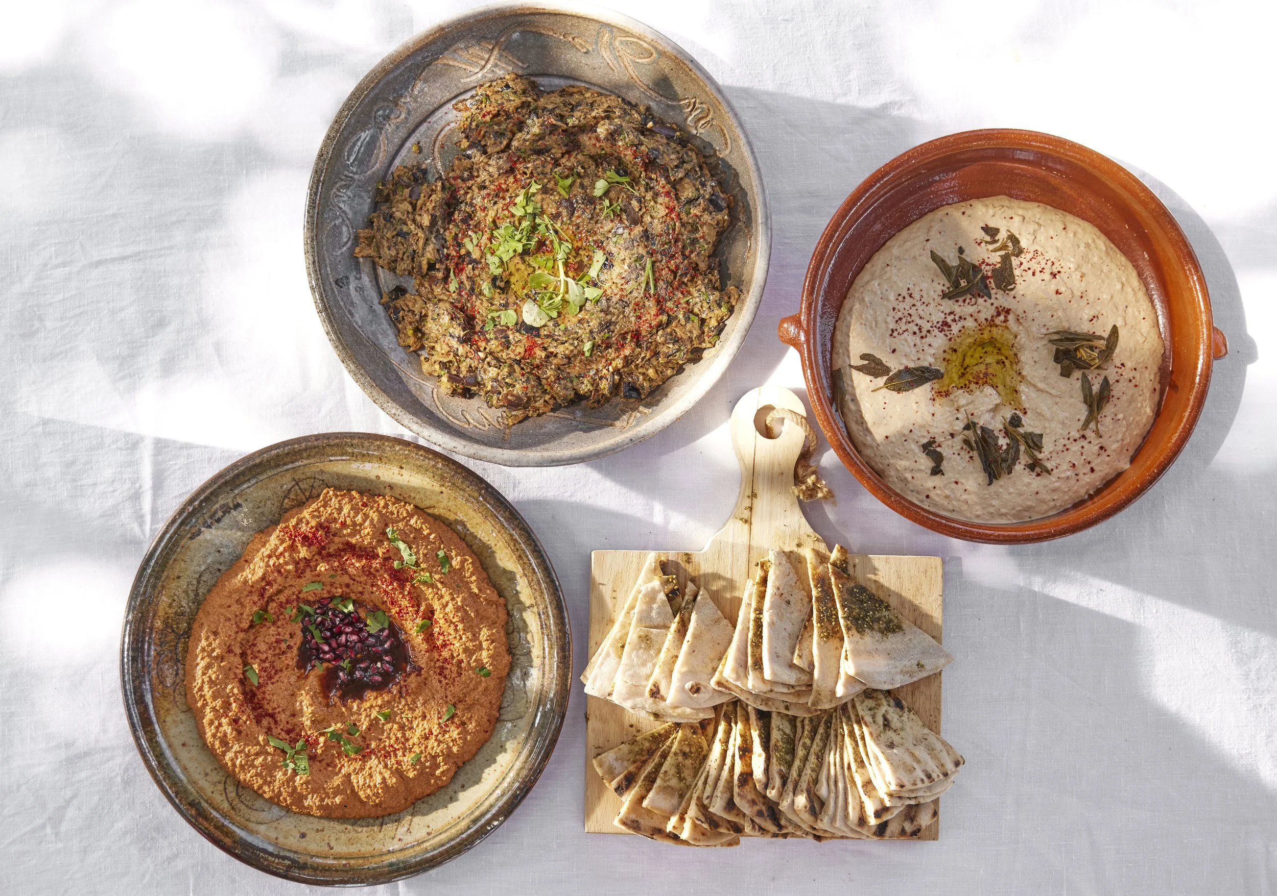 Ojai Rôtie house-made dips — hummus, muhammara, and za'atar with grilled manouche