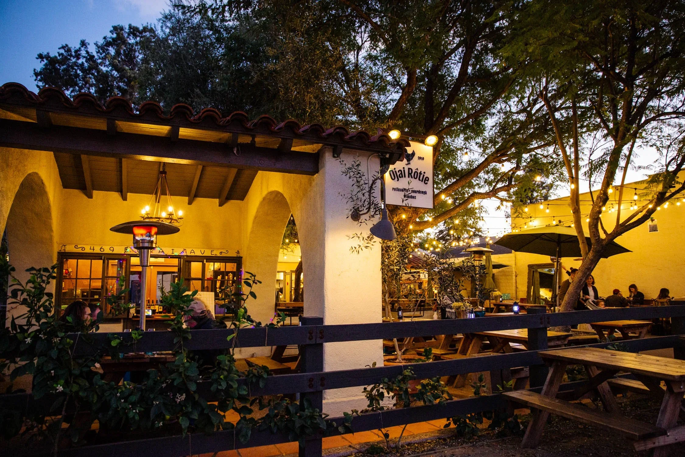 Ojai Rôtie flagship location at 469 East Ojai Avenue — patio dining under the landmark tipuana tree in historic downtown Ojai