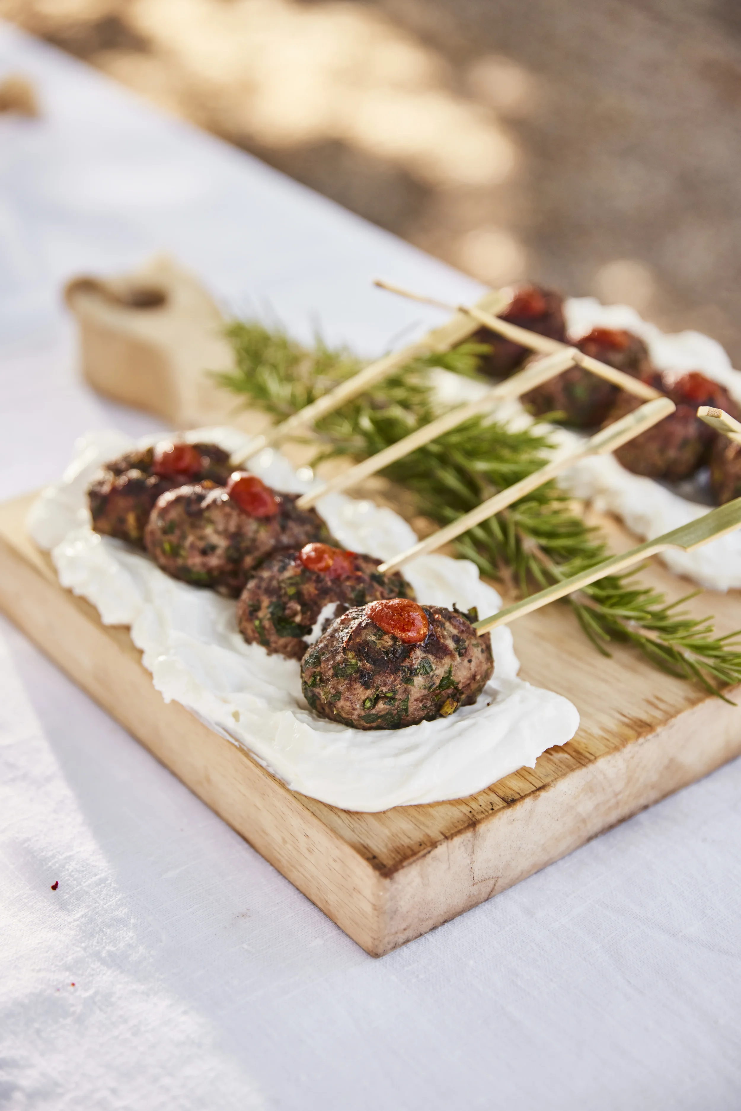 House-made lamb kafta skewers at an Ojai Rôtie catering event — served with harissa and lebne