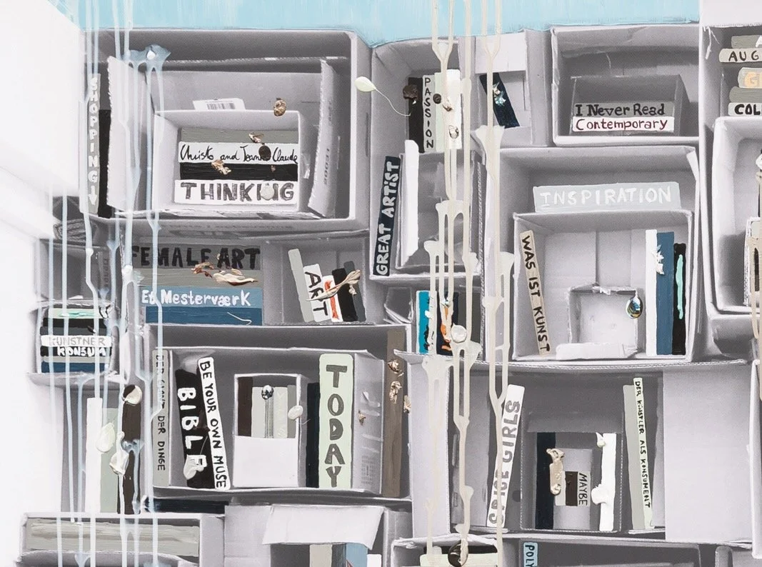 A bookshelf with storage boxes containing books and decorative items, with drip-like paint or wax running down the side.