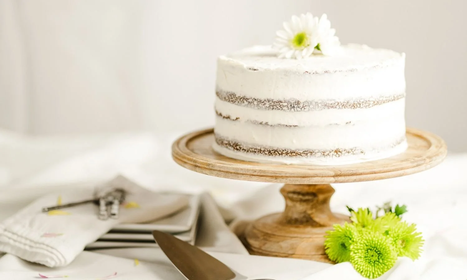 rosted gluten free carrot cake on pedestal