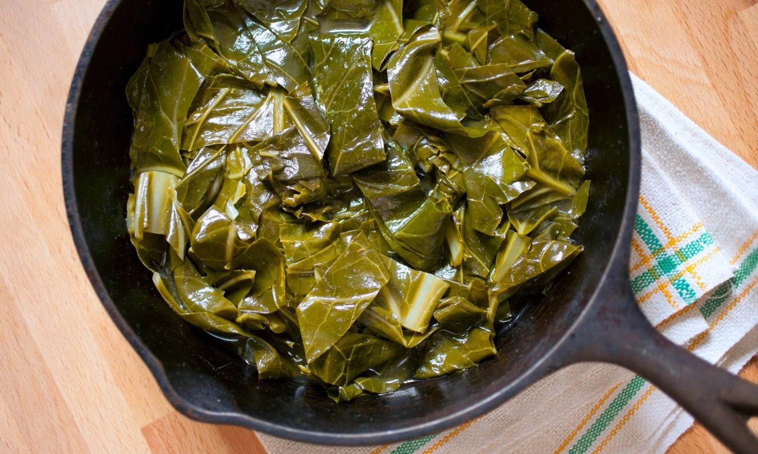 Slow cooked collard greens in pan
