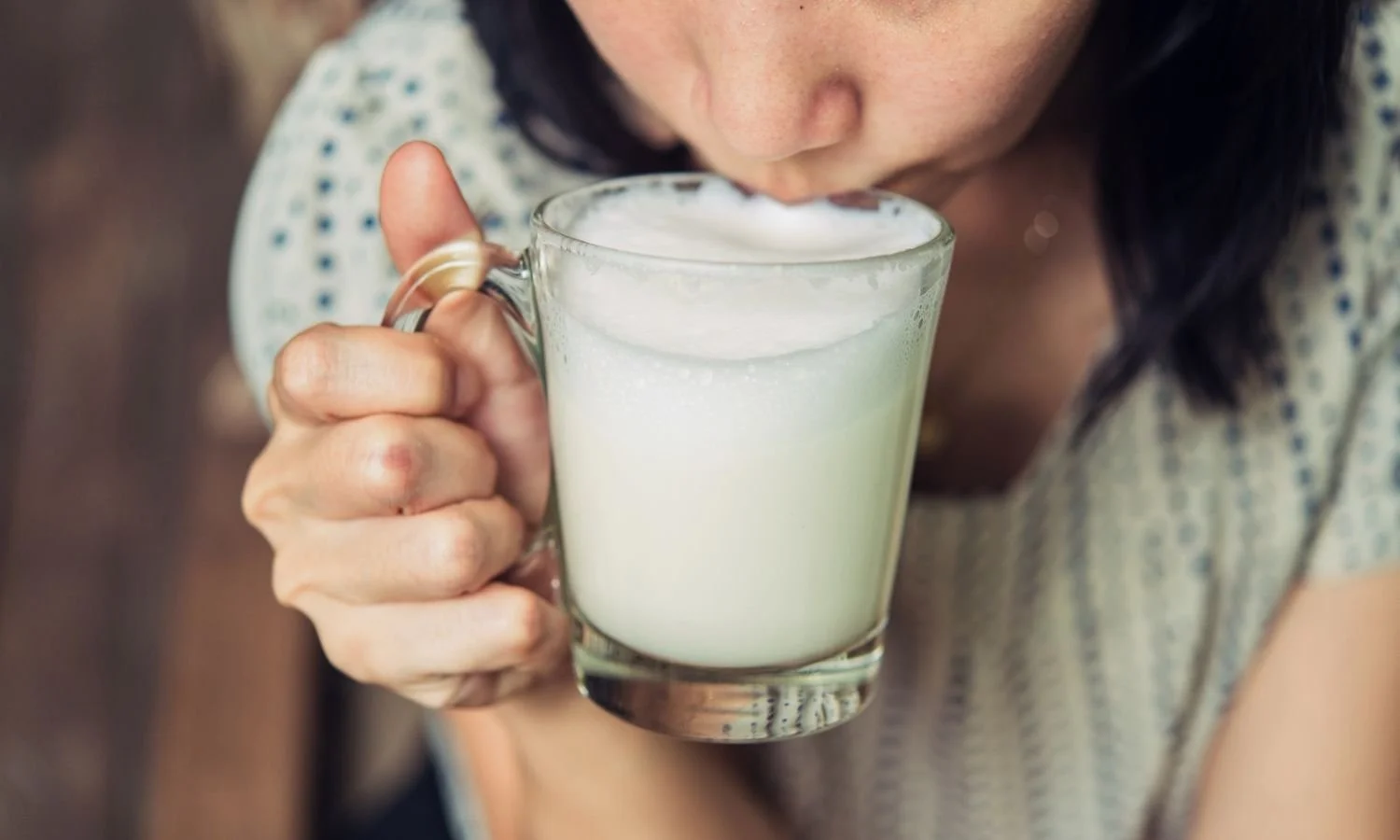 woman sipping almond milk