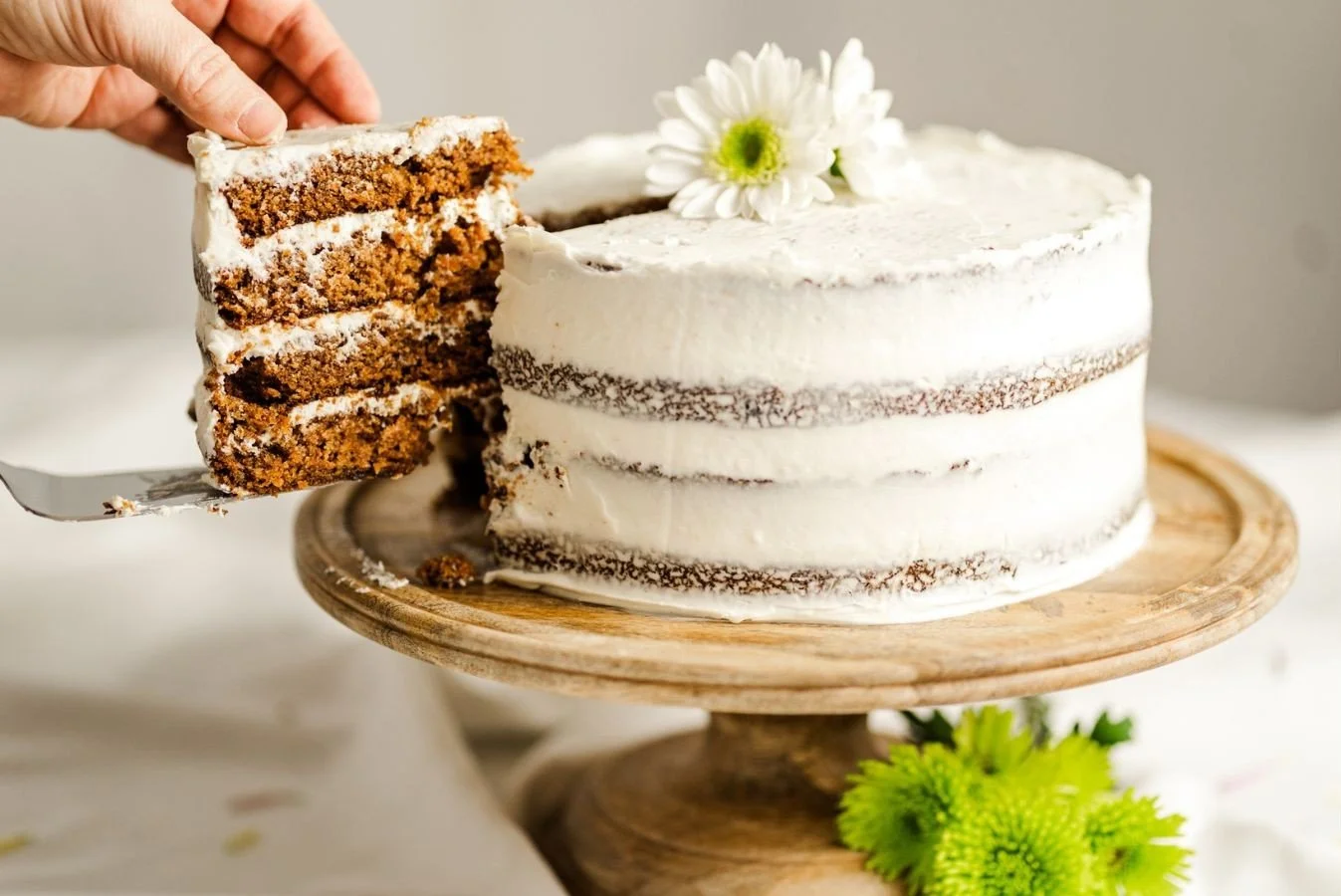 pulling out a slice of gluten free carrot cake