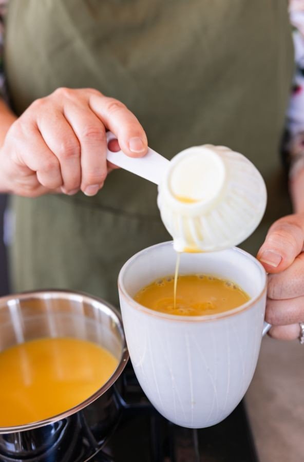 pouring Golden Turmeric Latte into mug