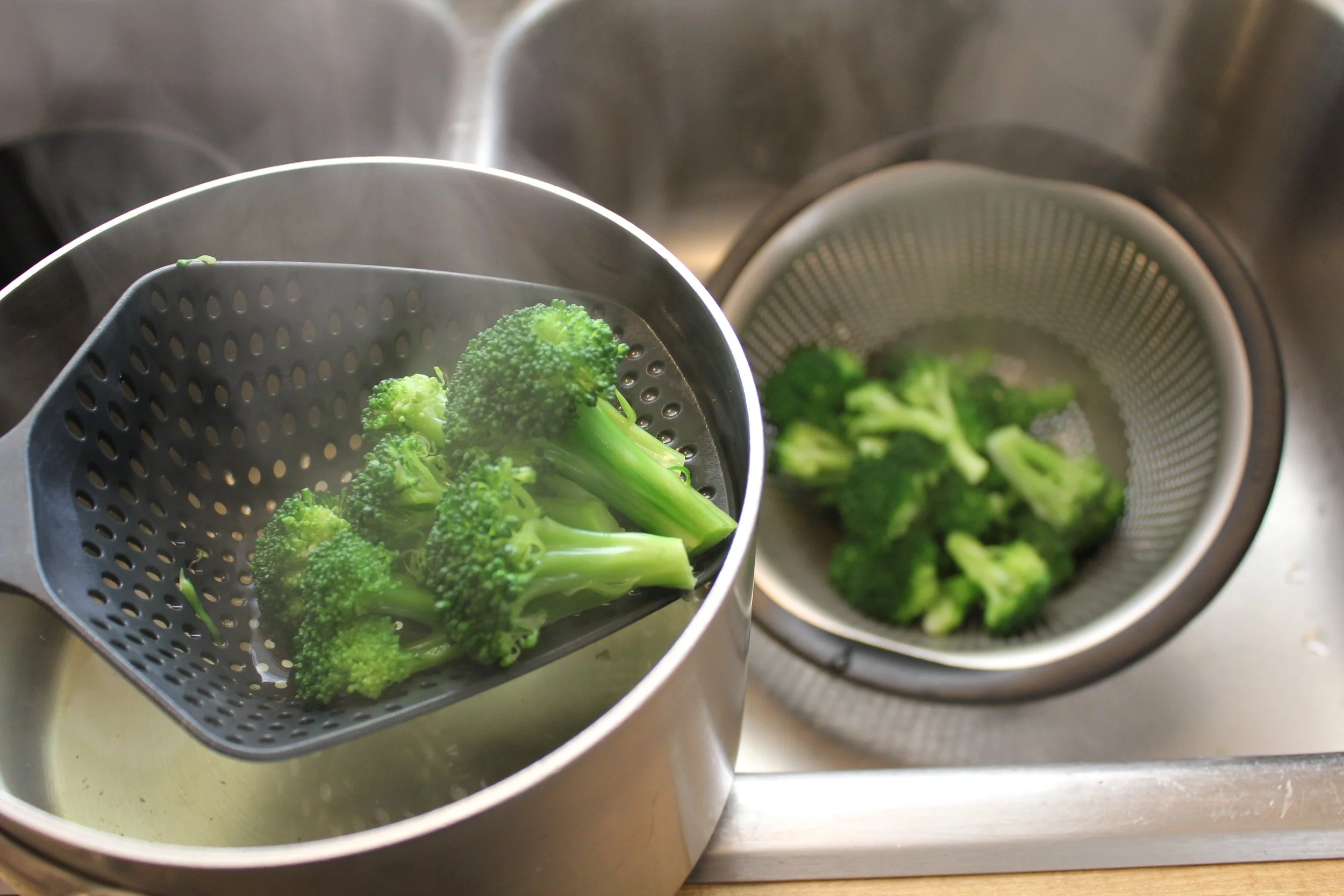 straining blanched broccoli