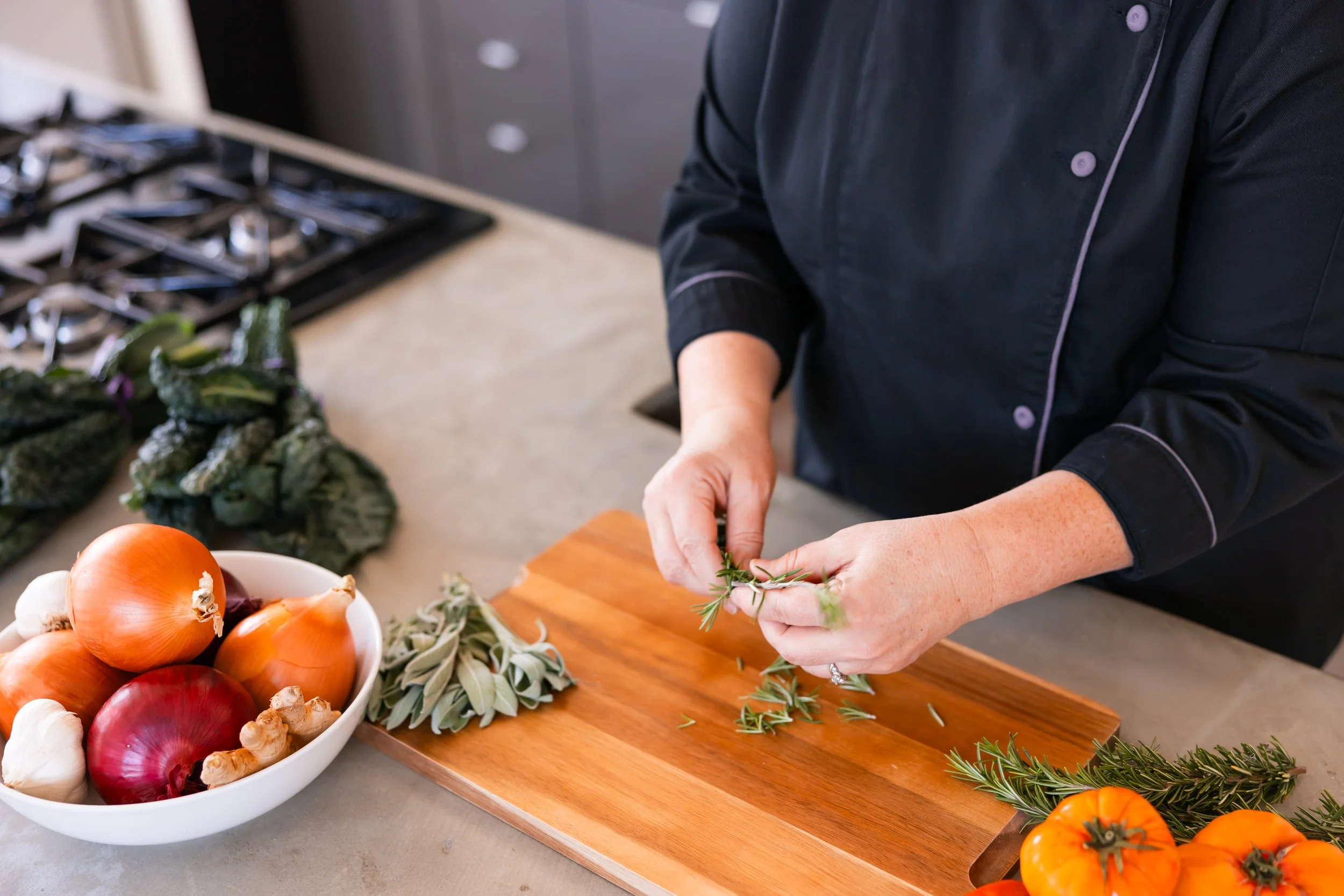 chef andreas hands picking rosemary