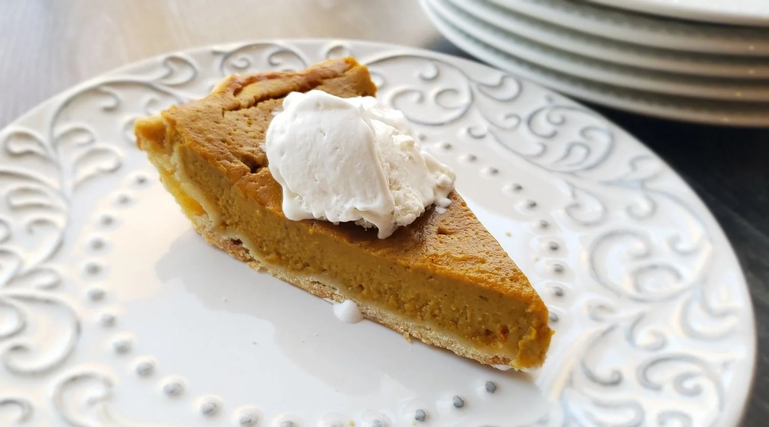 slice of gluten free pumpkin pie with vanilla ice cream