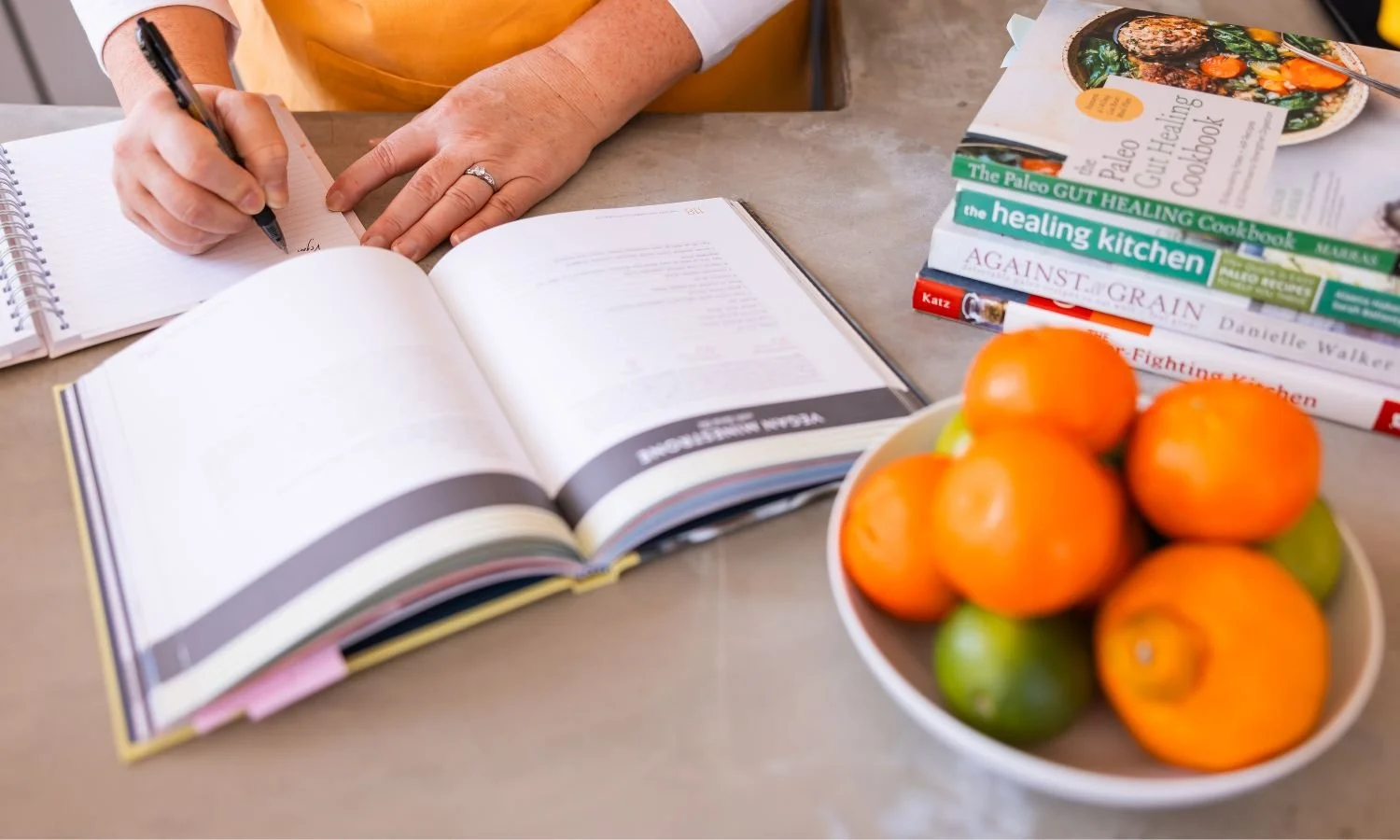chef andrea with stack of cookbooks