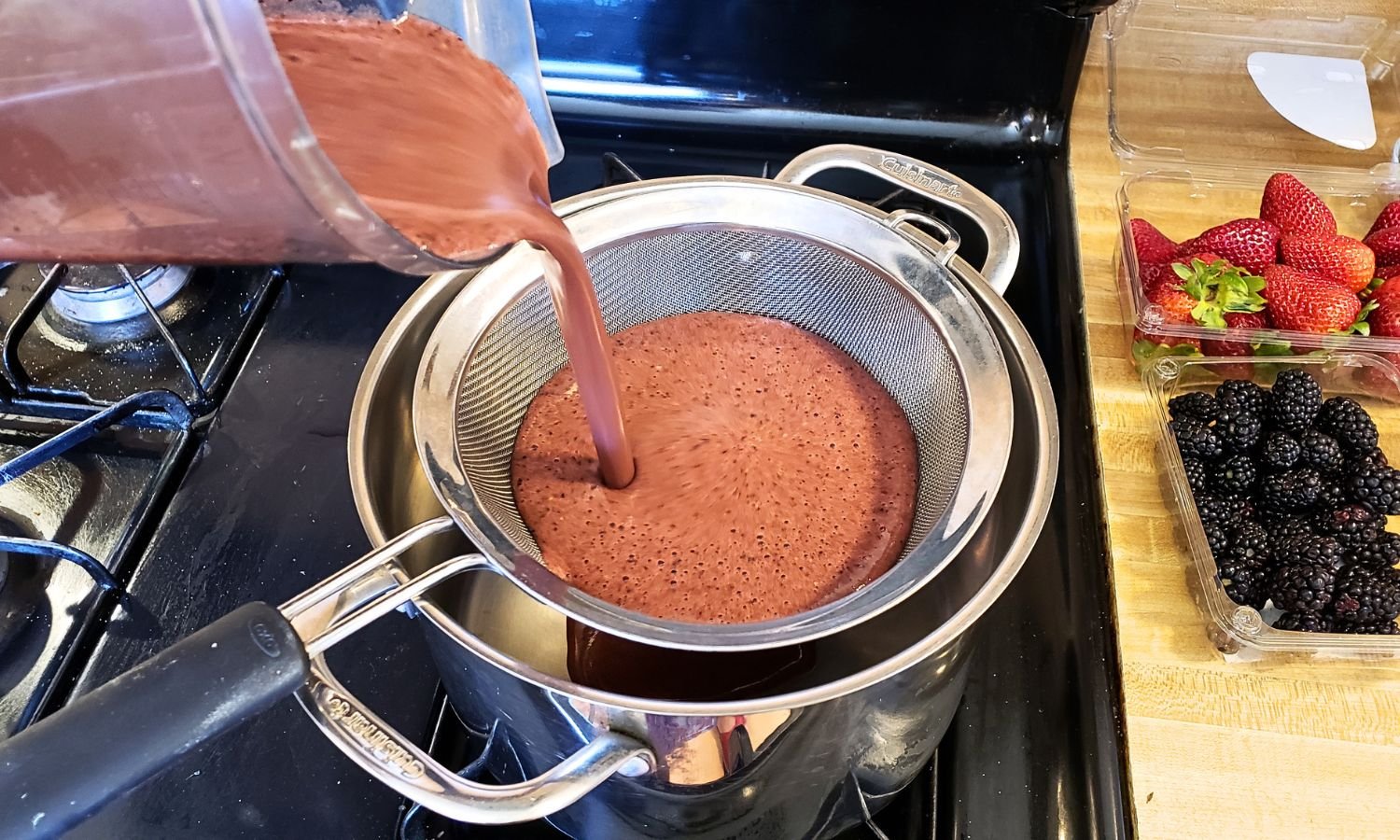pouring berry gelatin mix through strainer