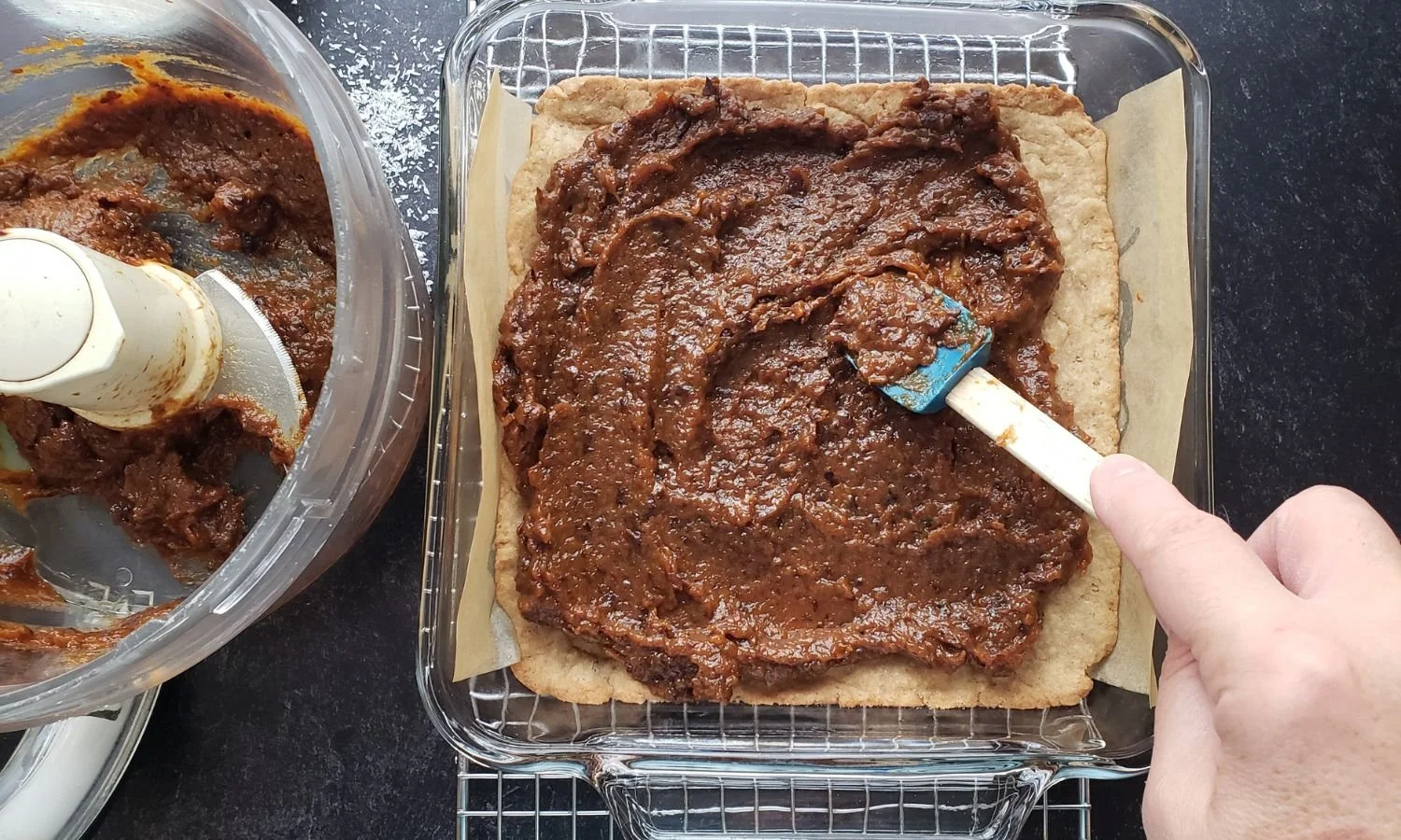 spreading on apricot topping to baked bar base for Apricot and Plum Coconut Bars