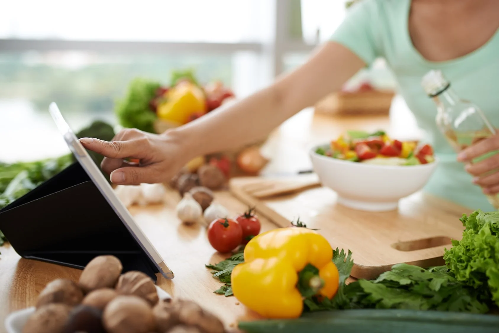 woman cooking with tablet