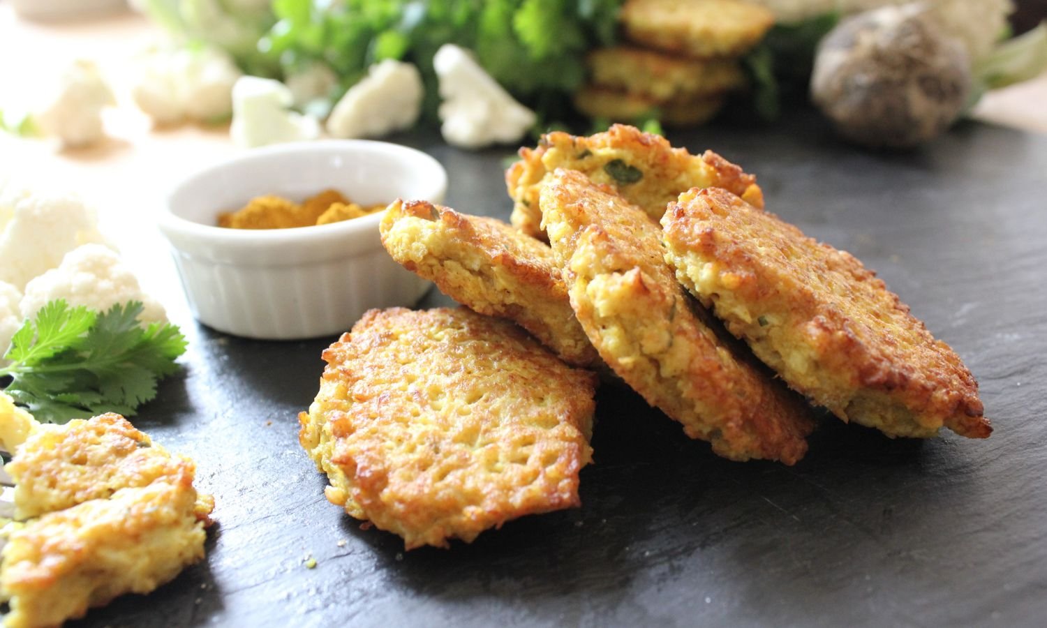 a pile of gluten free curried cauliflower fritters