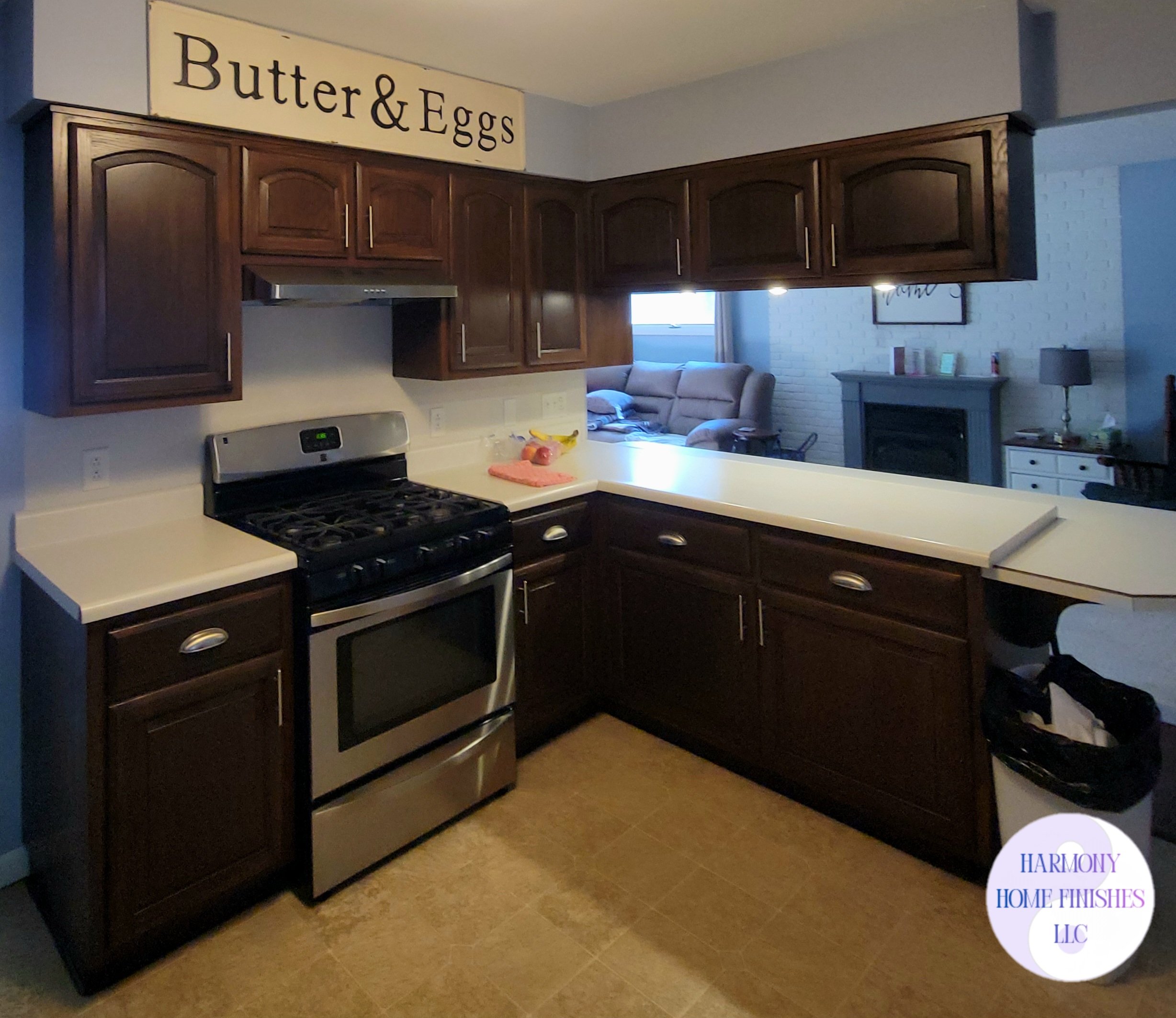 Before & After: From dated honey oak to a sophisticated dark walnut. These cabinets were professionally transformed using a high-quality gel stain, giving this kitchen a modern, high-end look without the cost of a full replacement!