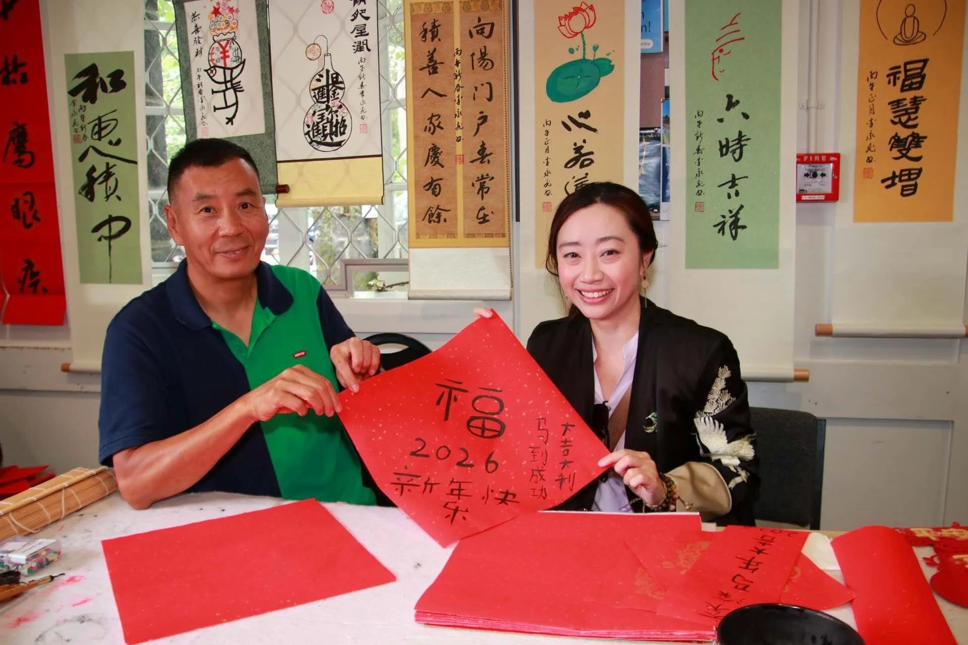 Chinese Association members holding up calligraphy