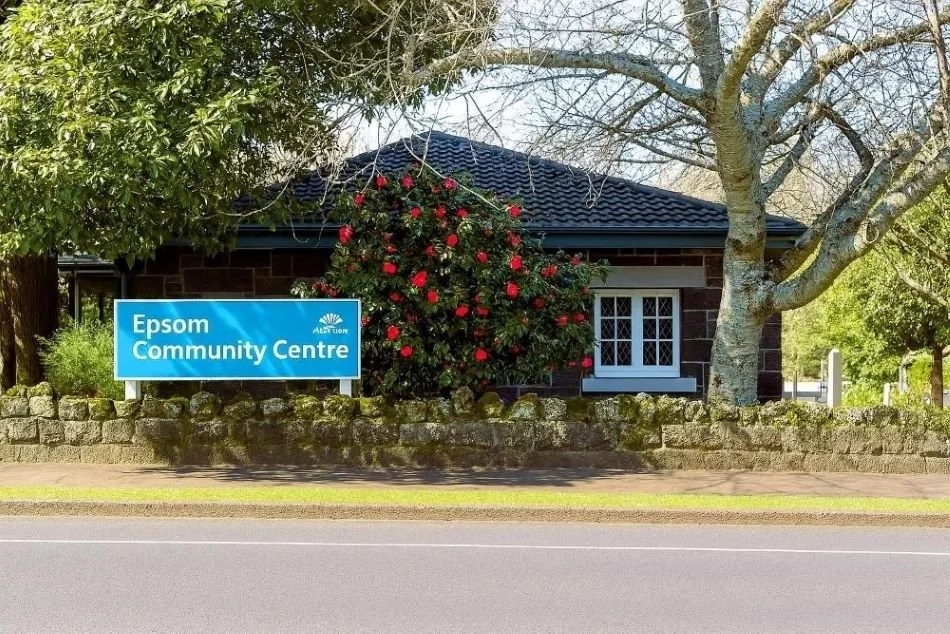 Front of Epsom Community Centre view from street with sign and trees