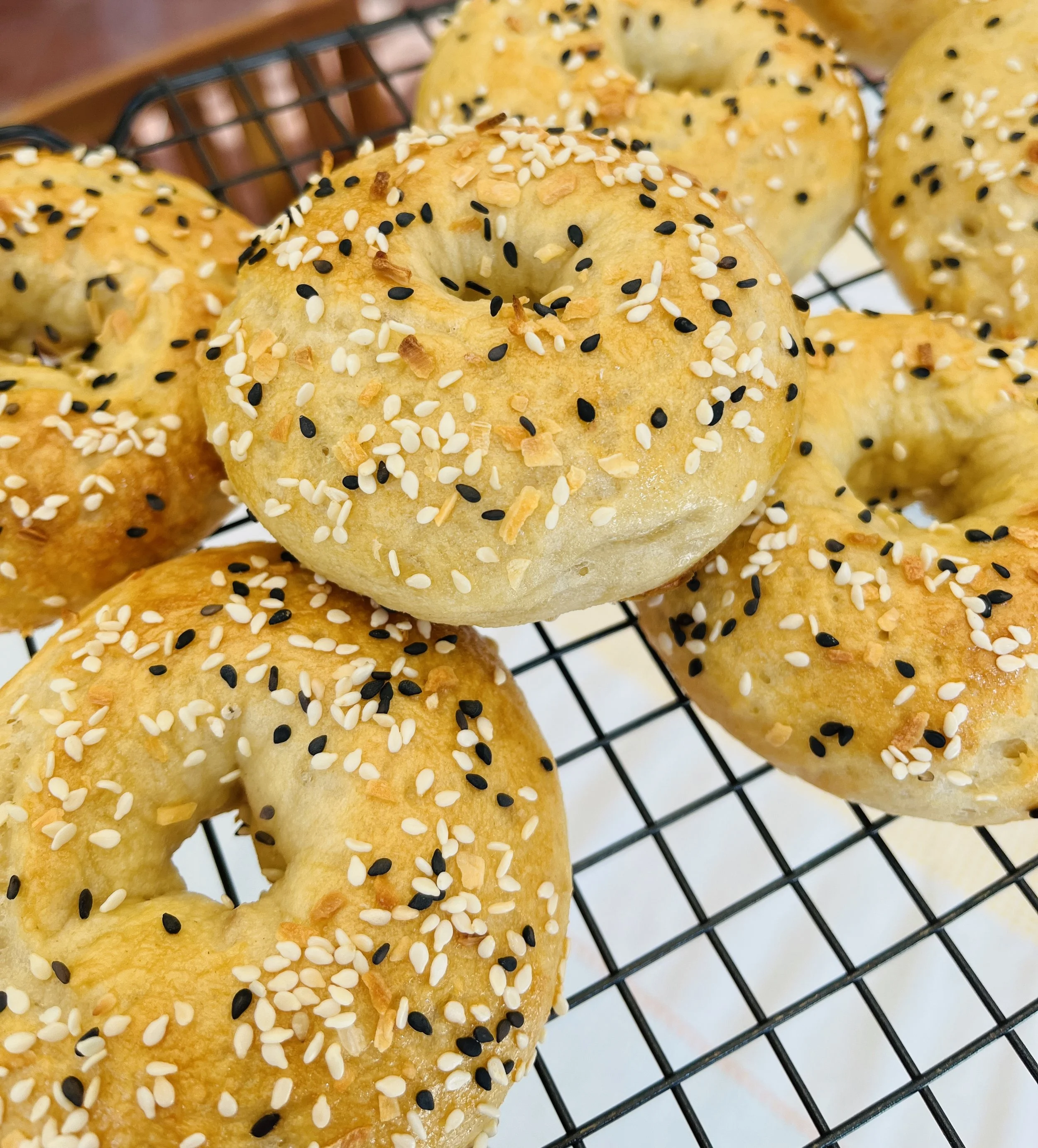 Gluten free bagels with sesame seeds and dried onion.