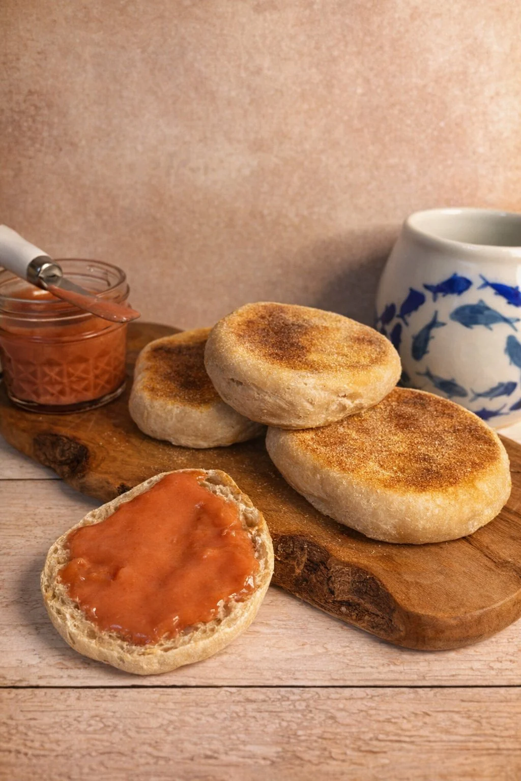 English breakfast with toasted bread, jam, and a blue and white pitcher in the background.