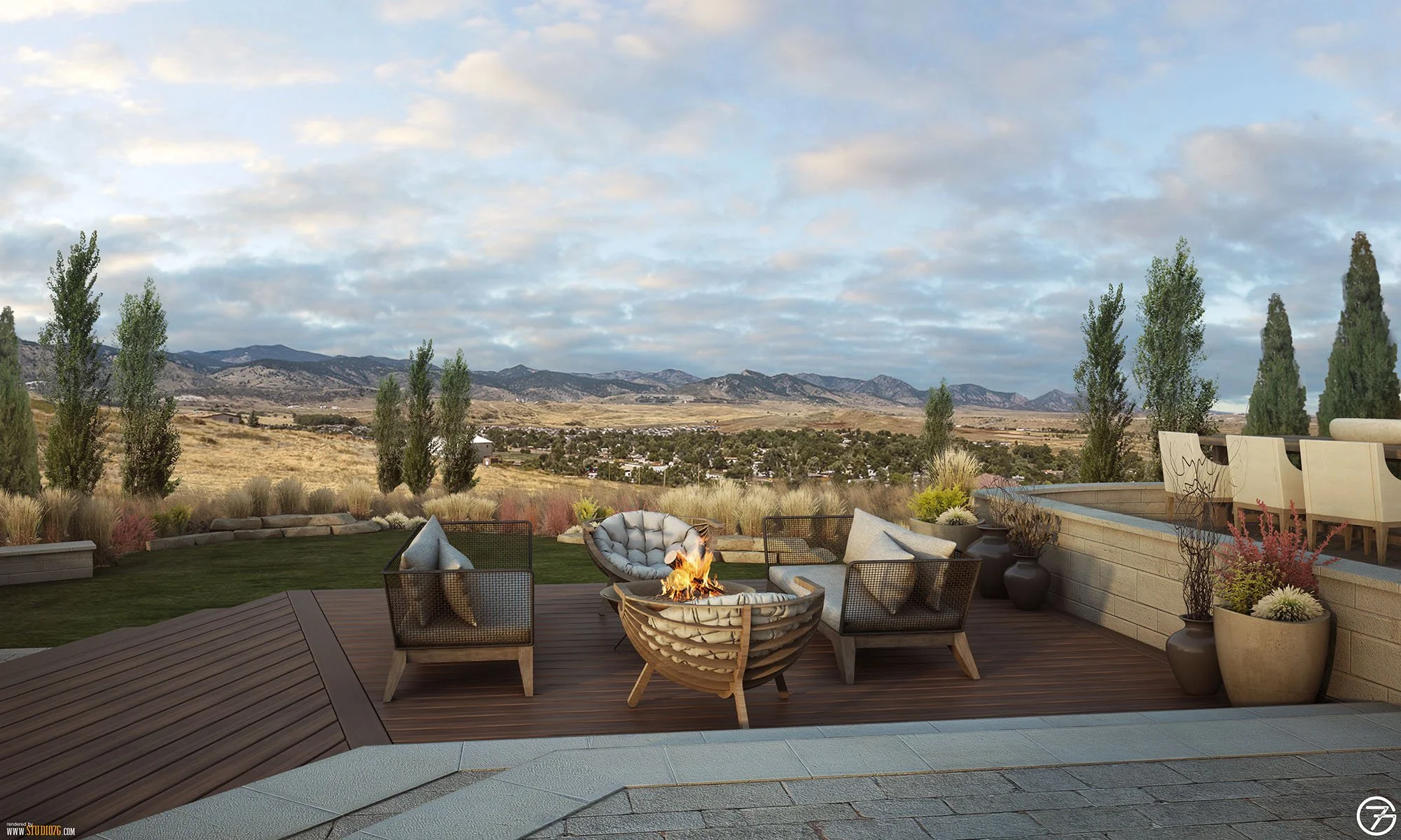 Outdoor patio with a fire pit, chairs, and potted plants, overlooking a landscape of trees, hills, and mountains under a partly cloudy sky.