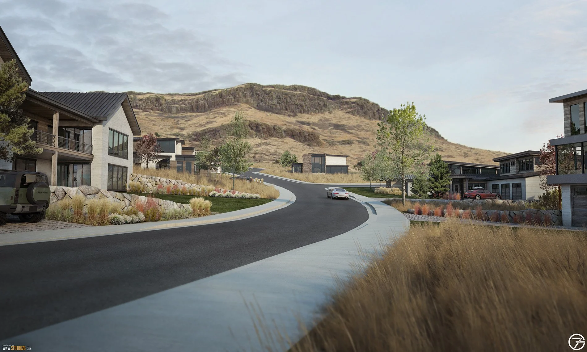 A curved residential street with modern houses, landscaped yards, trees, and a car, against a backdrop of rocky hills and a cloudy sky.