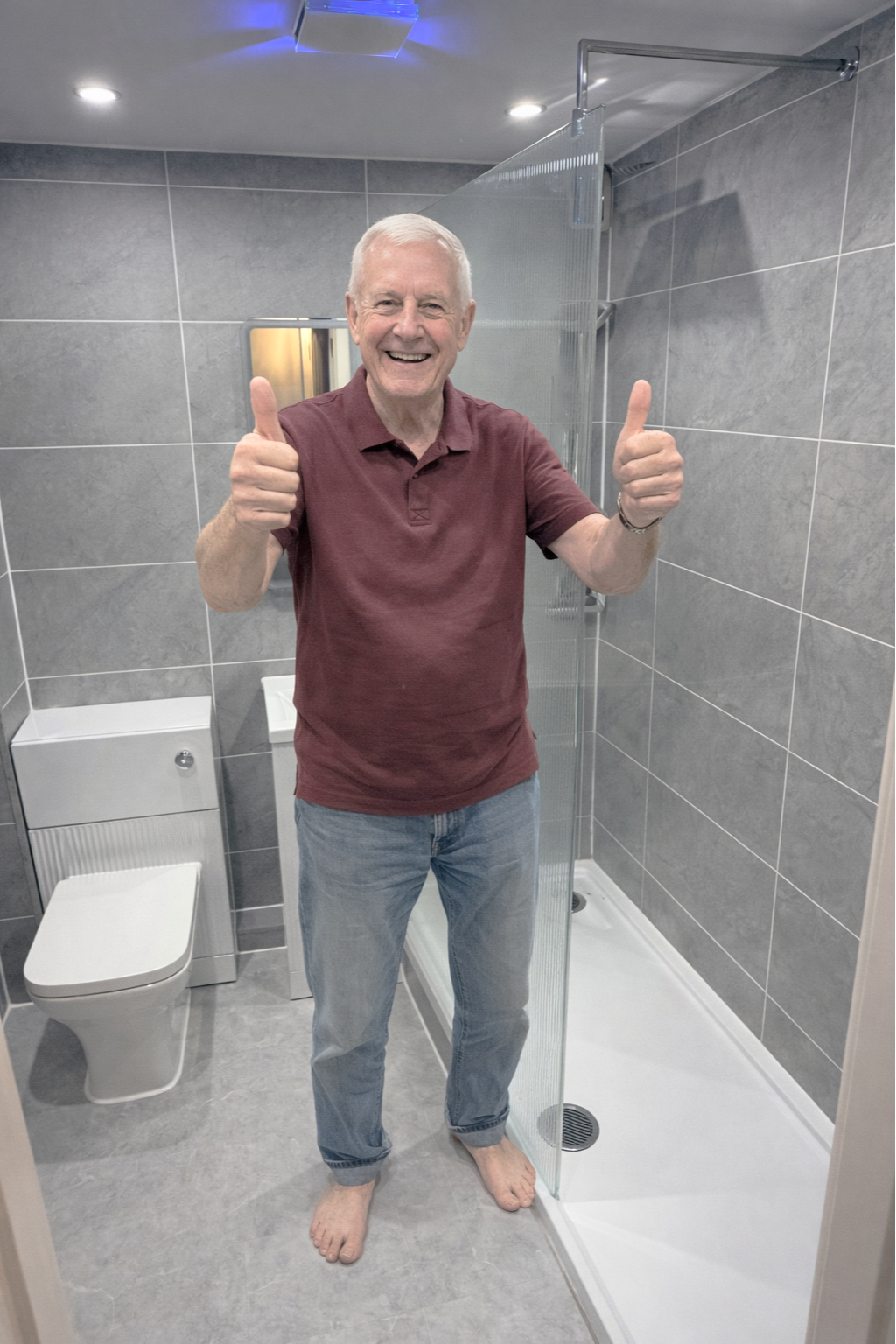 Delighted client showing finished bathroom renovation with clean modern design in Manchester