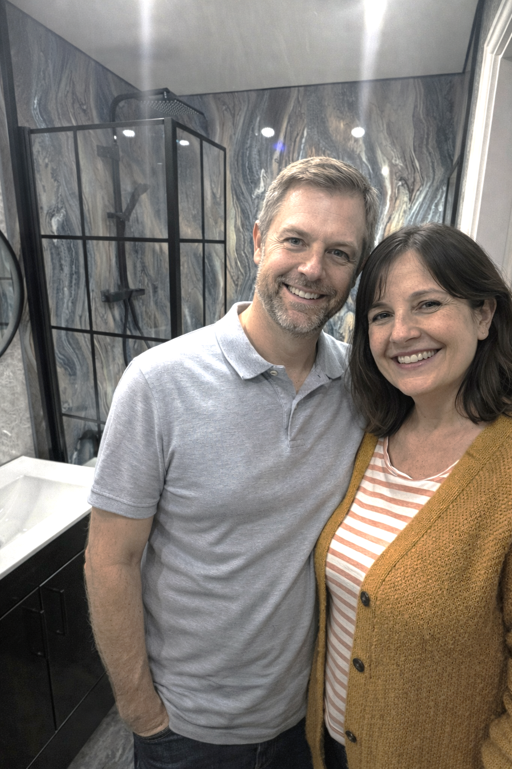 Happy couple after completing modern bathroom renovation in Manchester