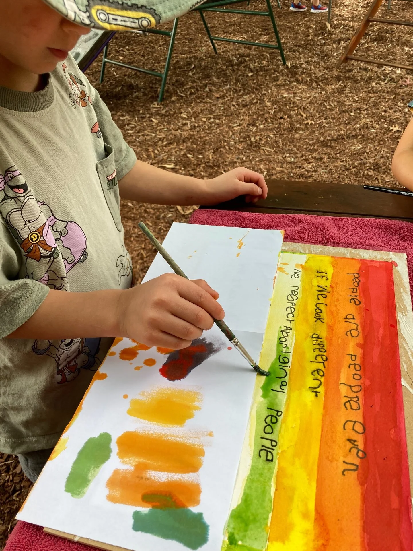 The children noticed that our framed Acknowledgement of Country sign had faded over time after years in the sun. This sparked a conversation about the group of children who originally created the sign 10 years ago and how we might carefully restore i