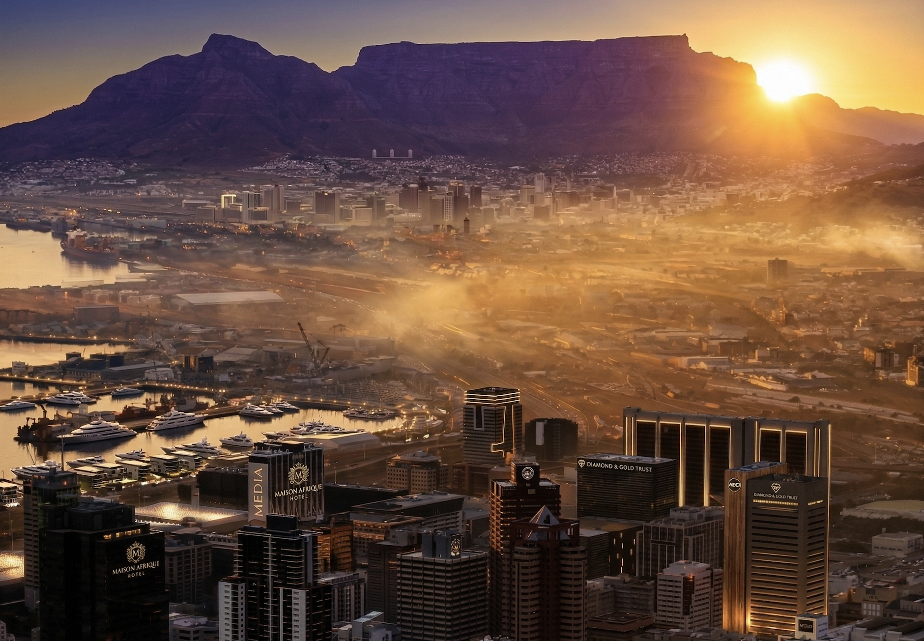 A city skyline at sunrise with high-rise buildings and a harbor with yachts and boats.