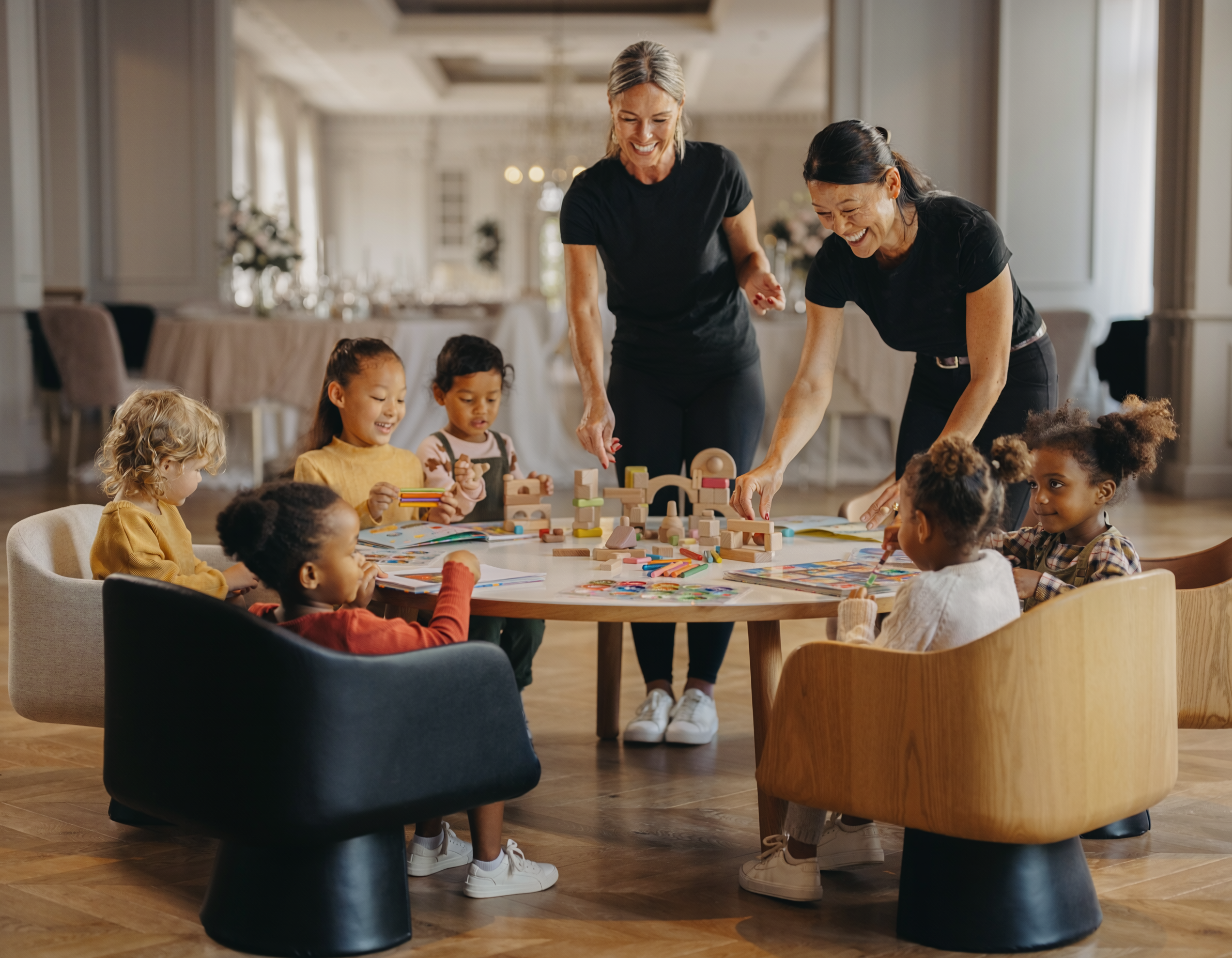 Staff laughing and playing with children