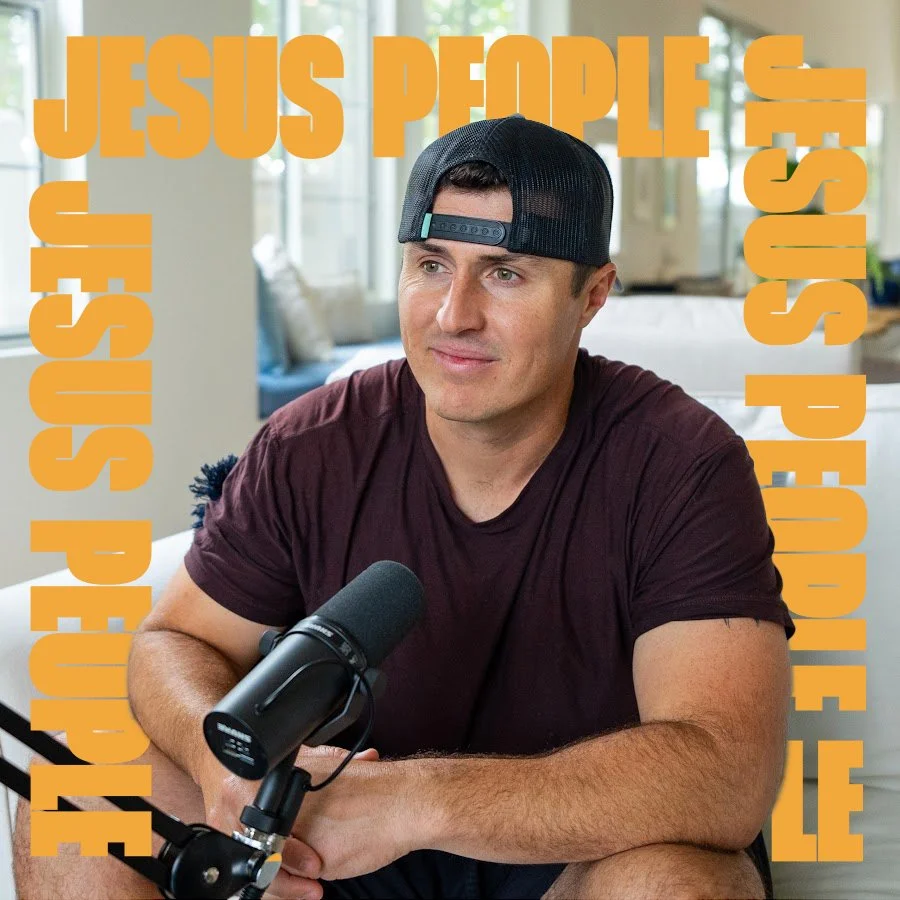 Ryan Miller wearing a black backwards cap and a maroon t-shirt sitting at a table with a microphone in front of him, with an overlay of orange text listing various religious groups.