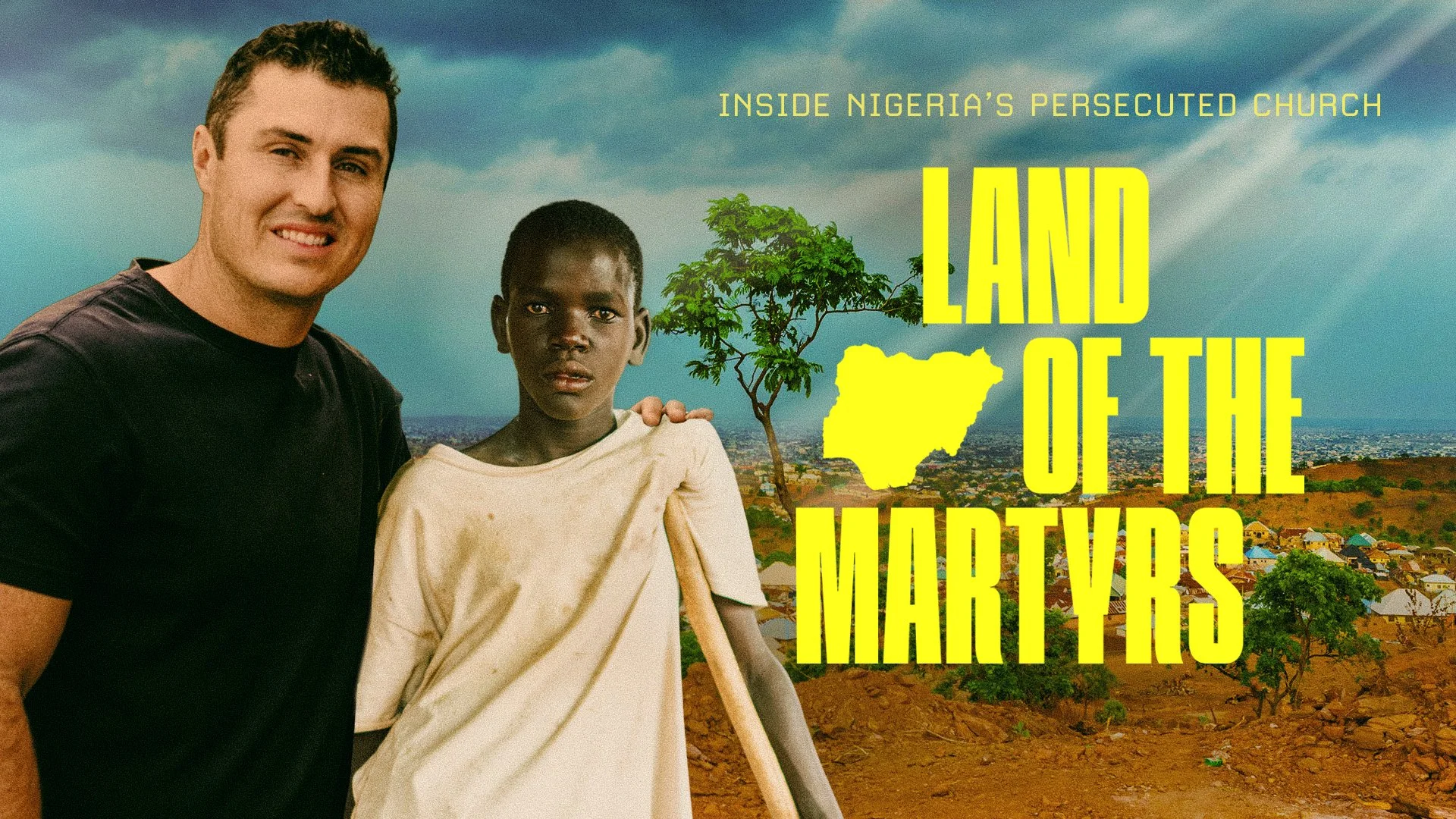 A promotional image for the documentary 'Land of the Martyrs' showing a man and a young boy in Nigeria, with a cityscape and cloudy sky in the background. The boy is holding a stick, and the text mentions Nigeria's persecuted church.