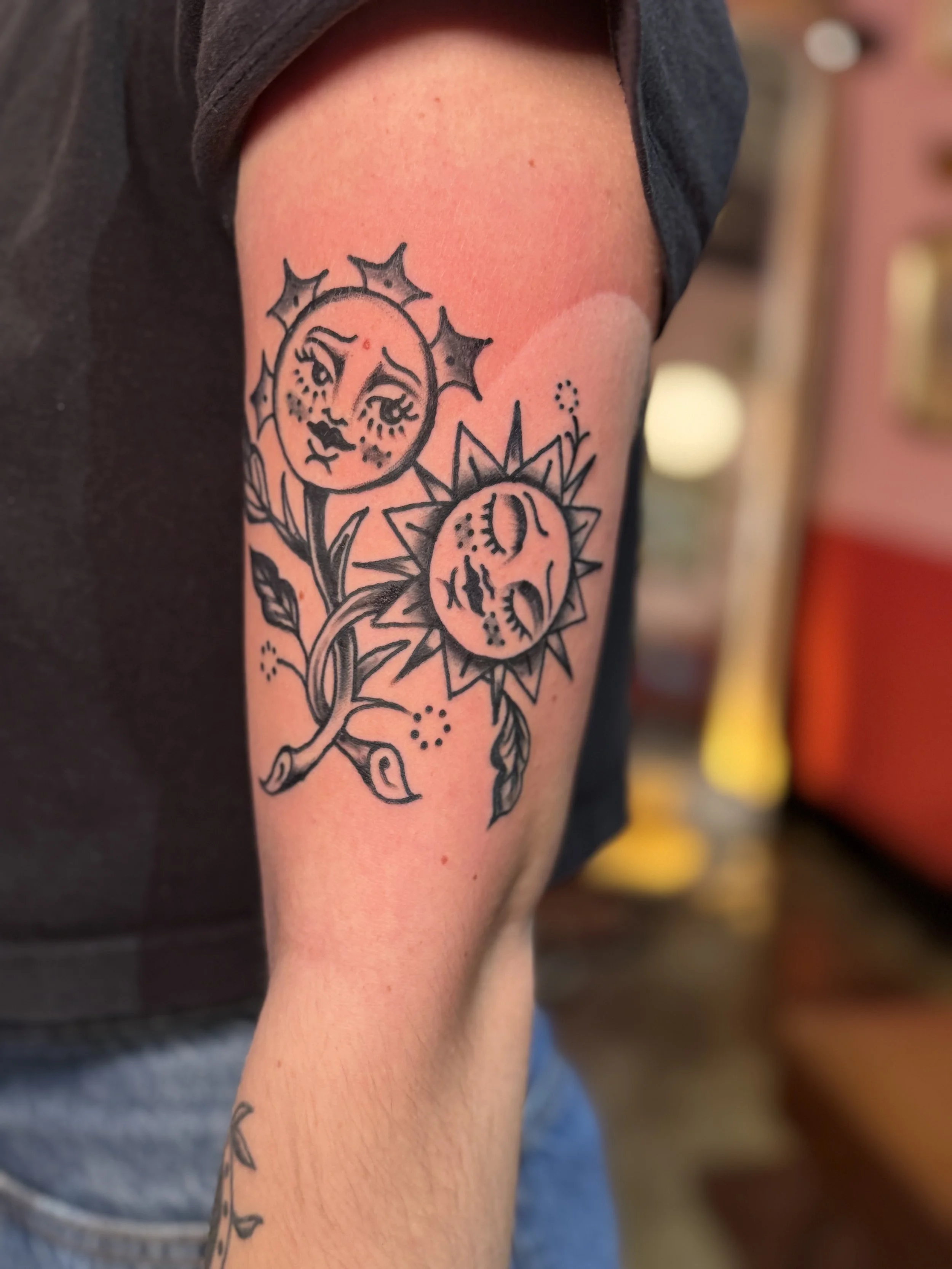 American traditional sun and moon tattoo pictured as flowers with little faces.