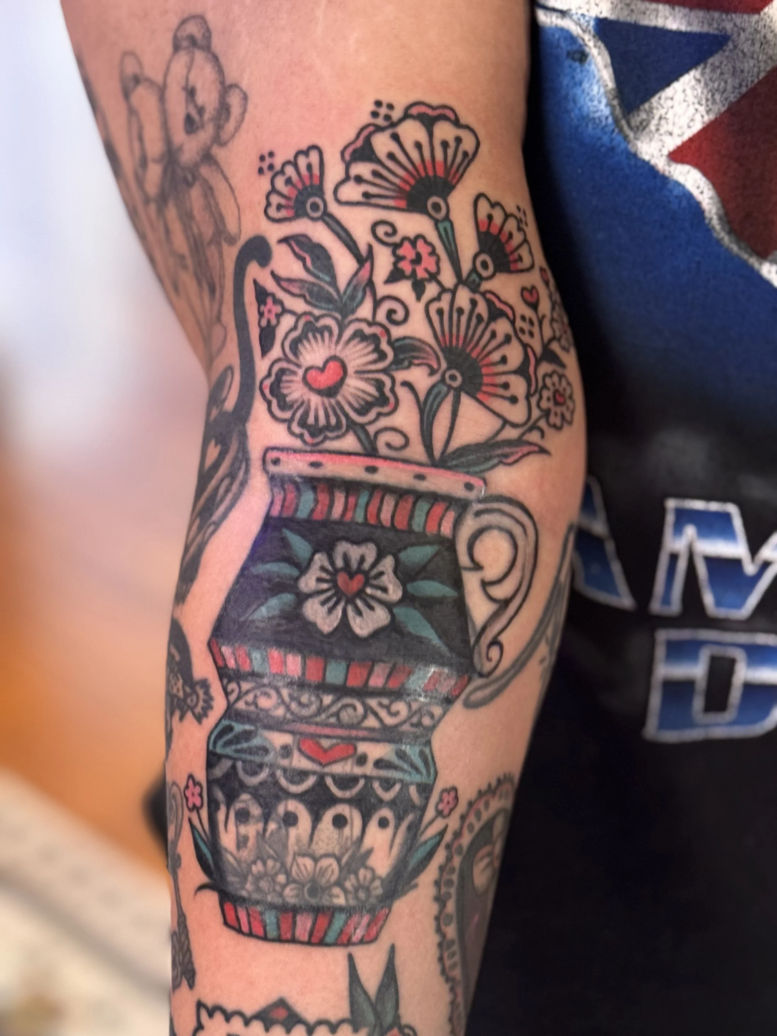 blast over tattoo of an american traditional vase with flowers