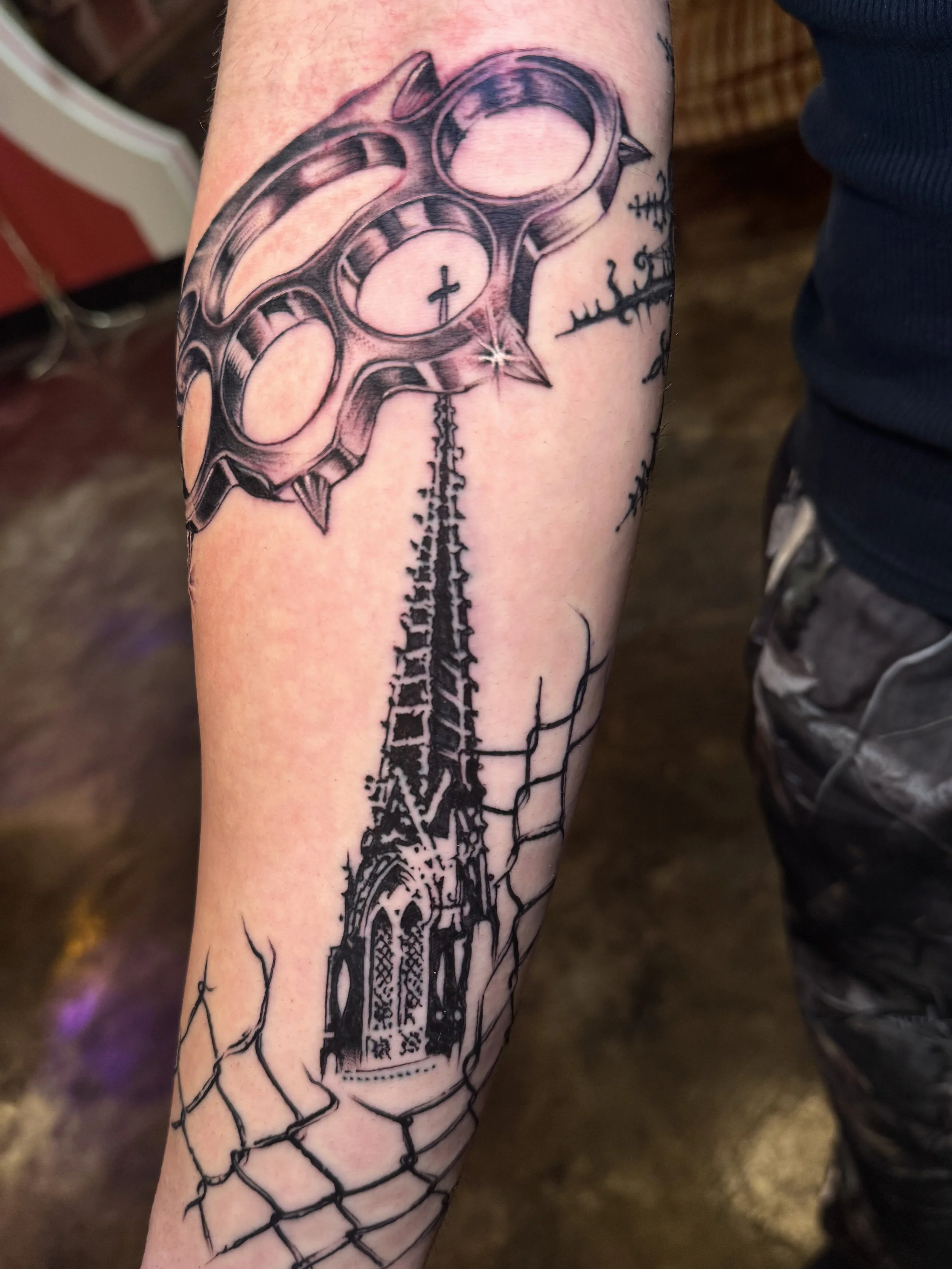 black and gray realistic brass knuckles and st. liborius church steeple