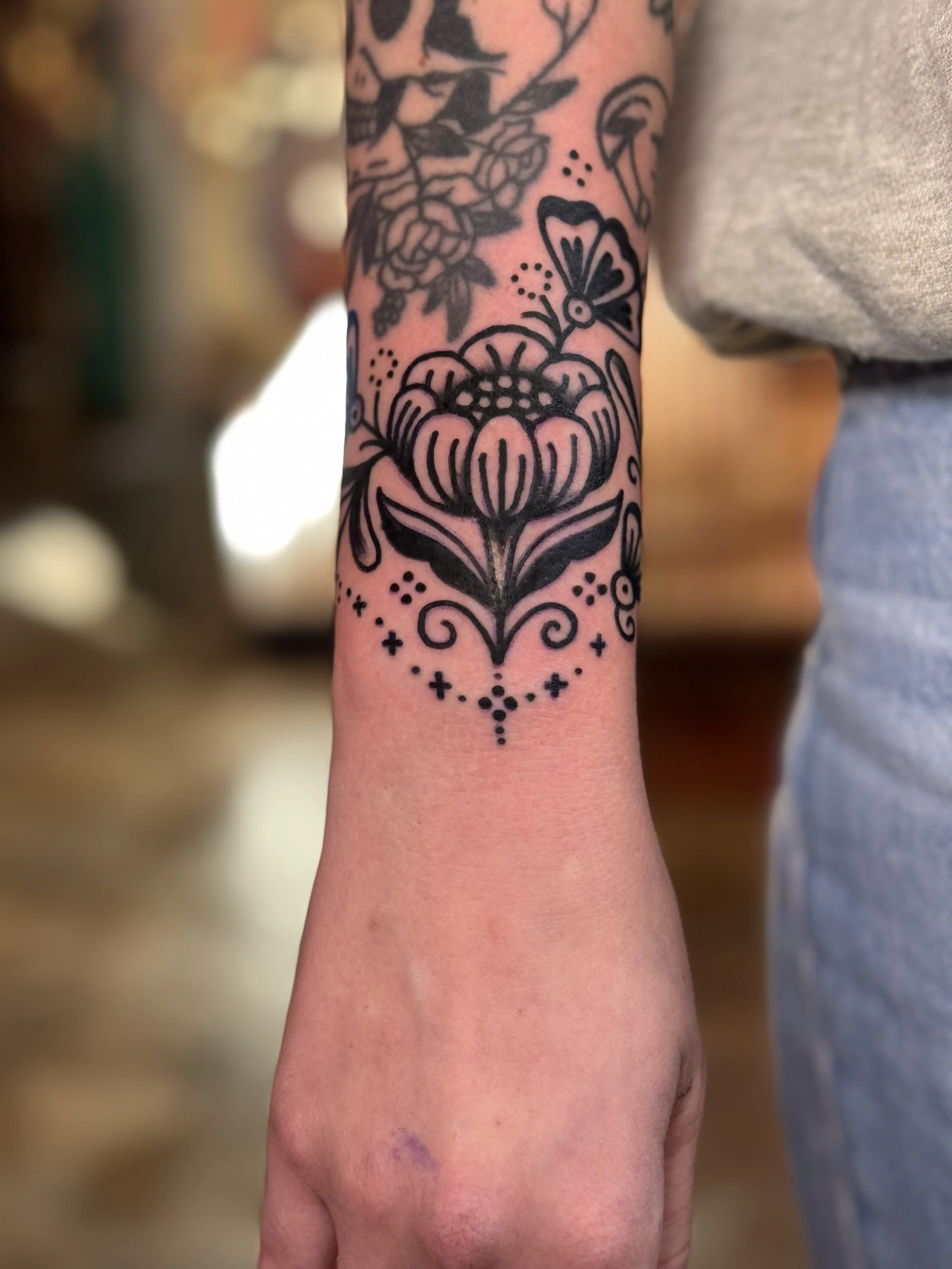 ornamental flower tattoo on the wrist