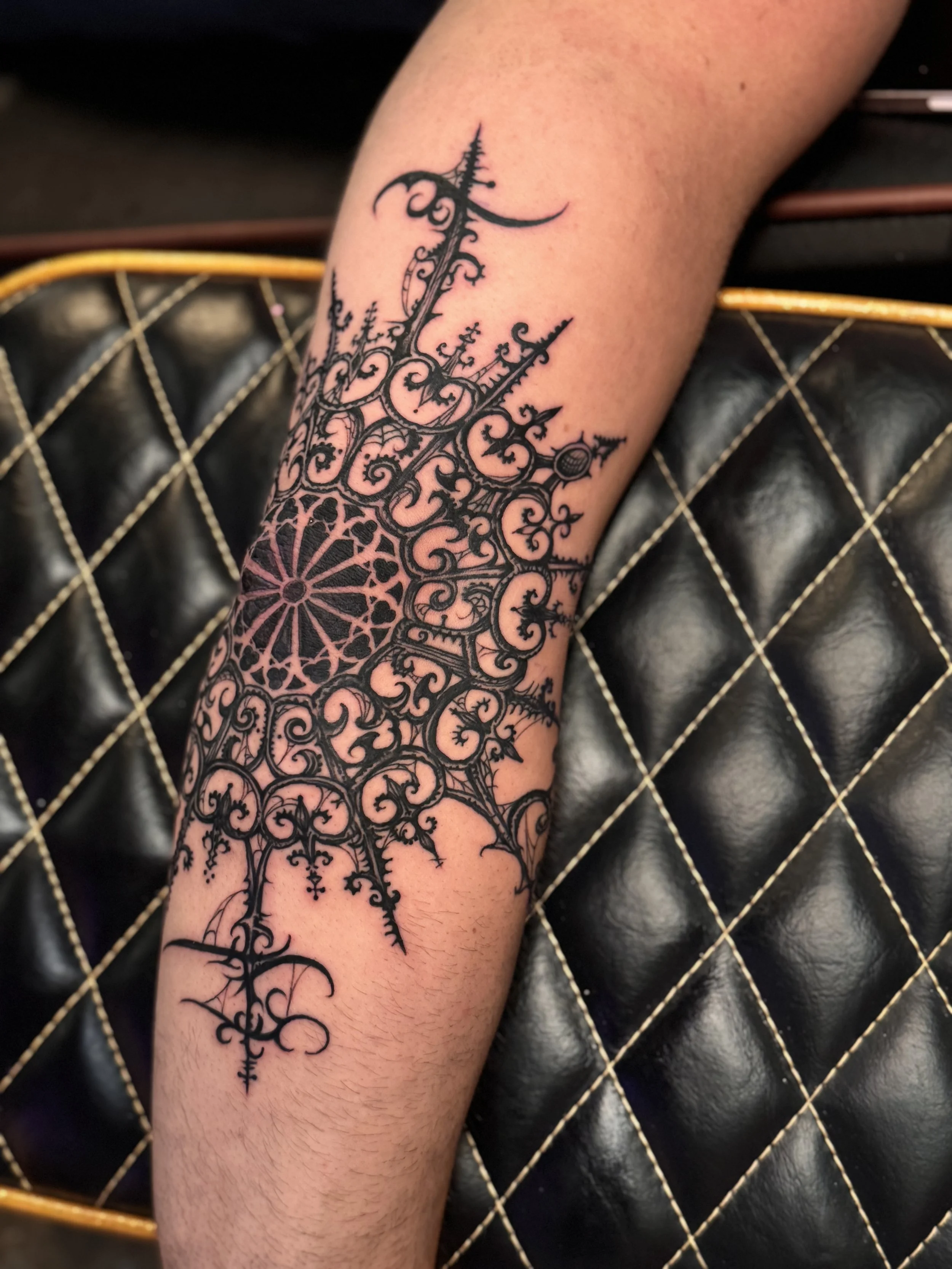Gothic ornamental elbow tattoo
