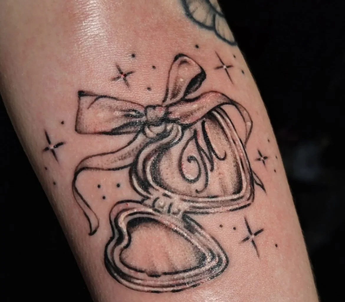 black and grey locket tattoo with initial