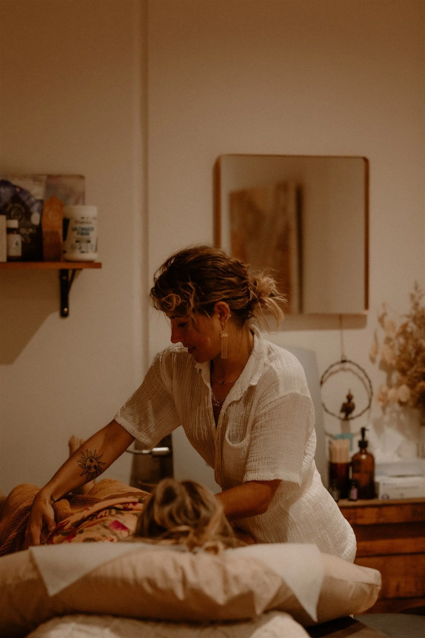 Naturopath preparing treatment table for client colonic consultation