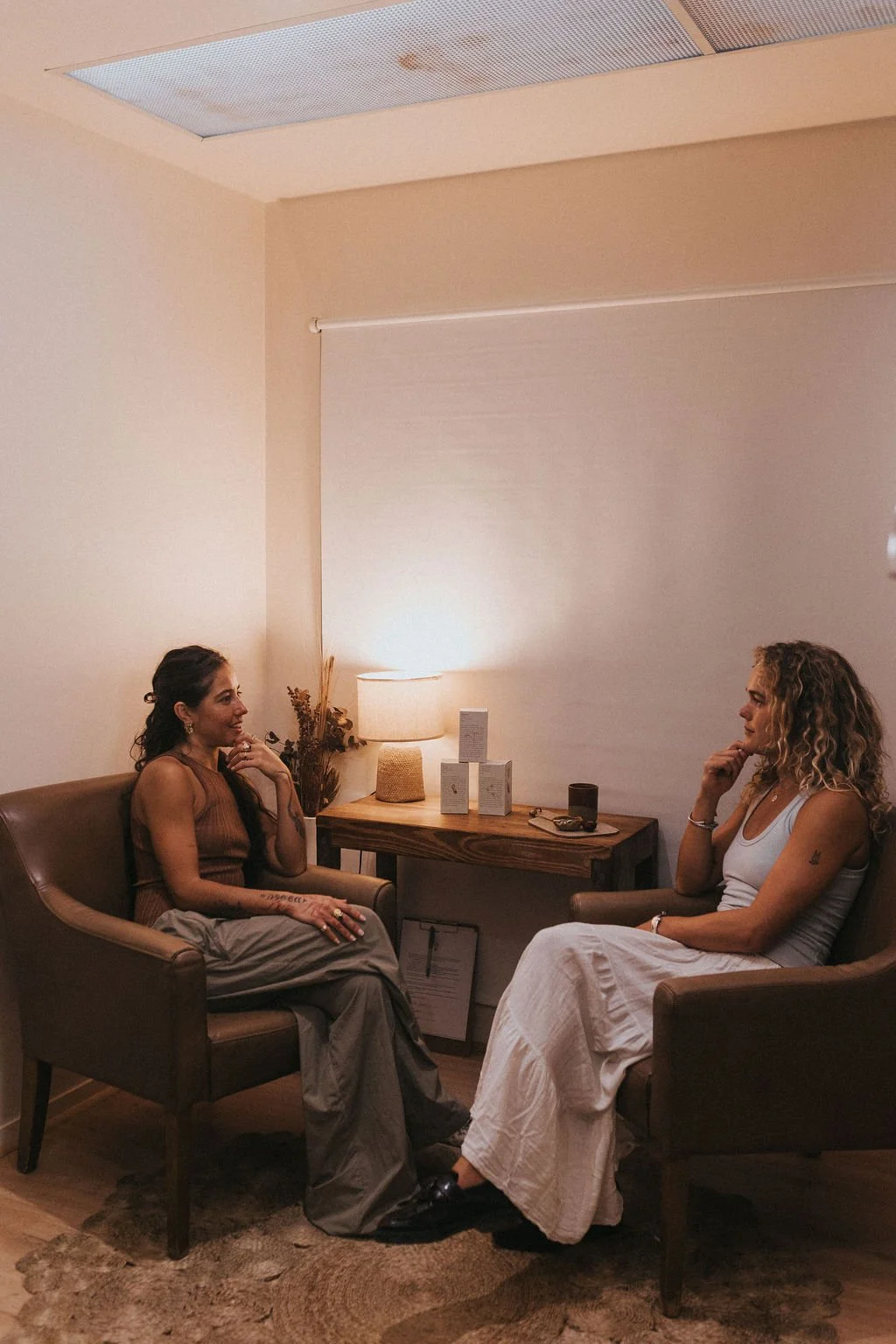 two women sitting in clinic space having a conversation