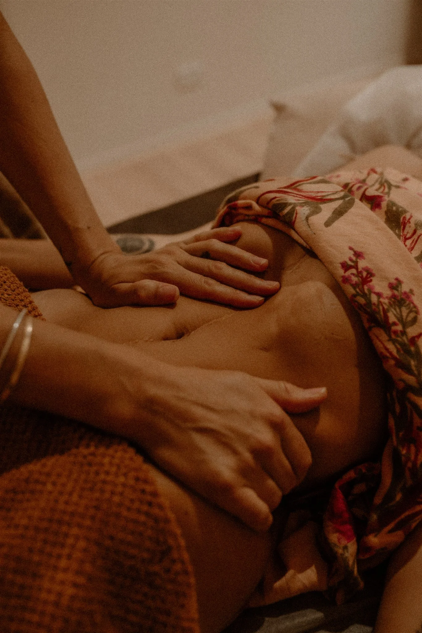 Qualified practitioner giving deep abdominal massage for therapeutic support