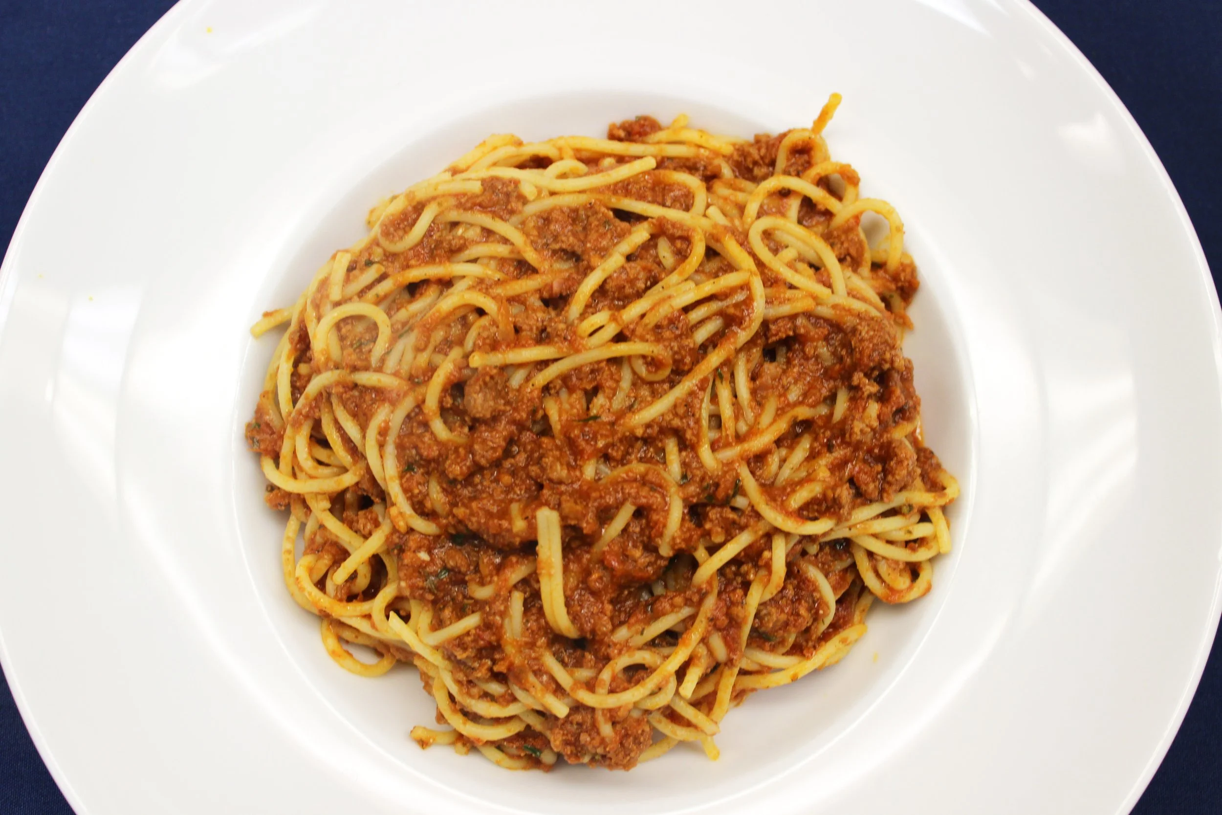 Spaghetti with meat sauce on a white plate.
