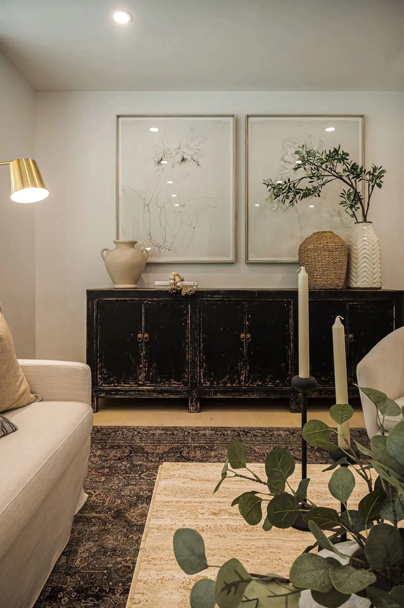 Living room with vintage cabinet styling and layered artwork home staging in Toronto Ontario by JT & Co Interiors