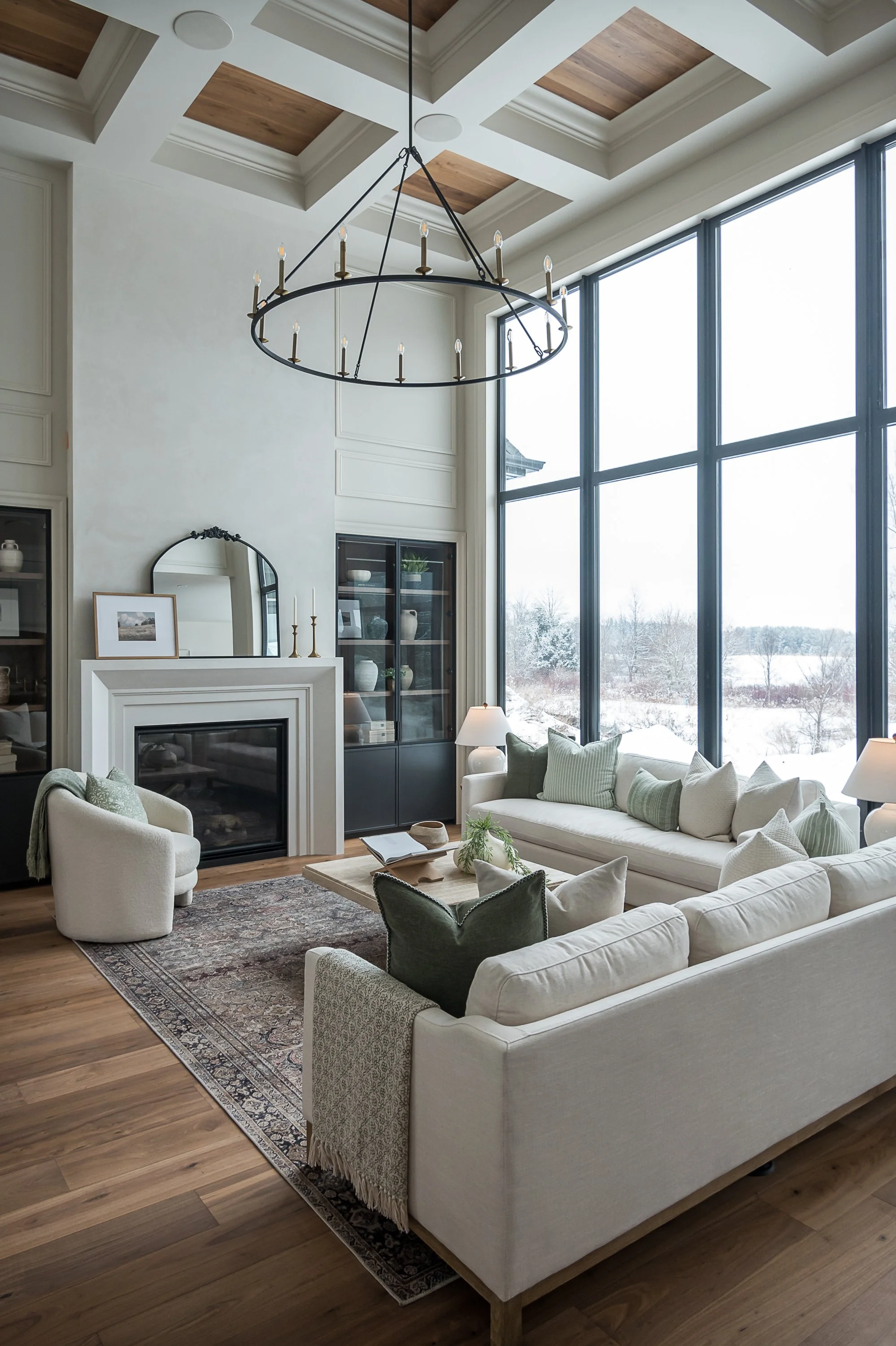 Living room with coffered ceiling and statement chandelier interior design in Oakville Ontario by JT & Co Interiors