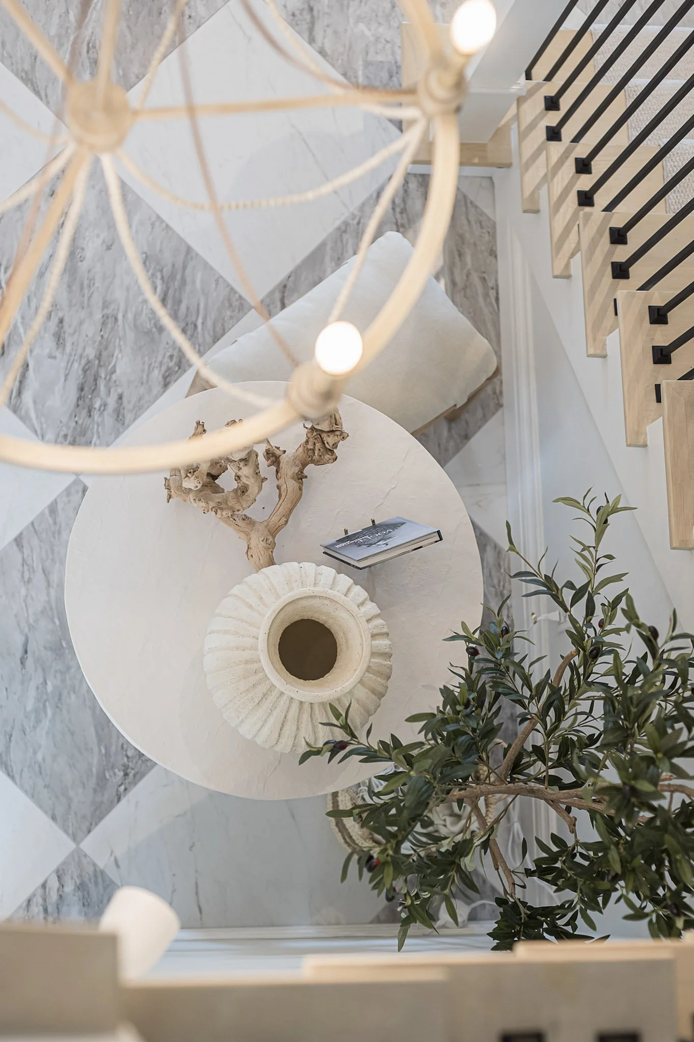 Entryway with marble checkerboard flooring and round table interior design in Toronto Ontario by JT & Co Interiors