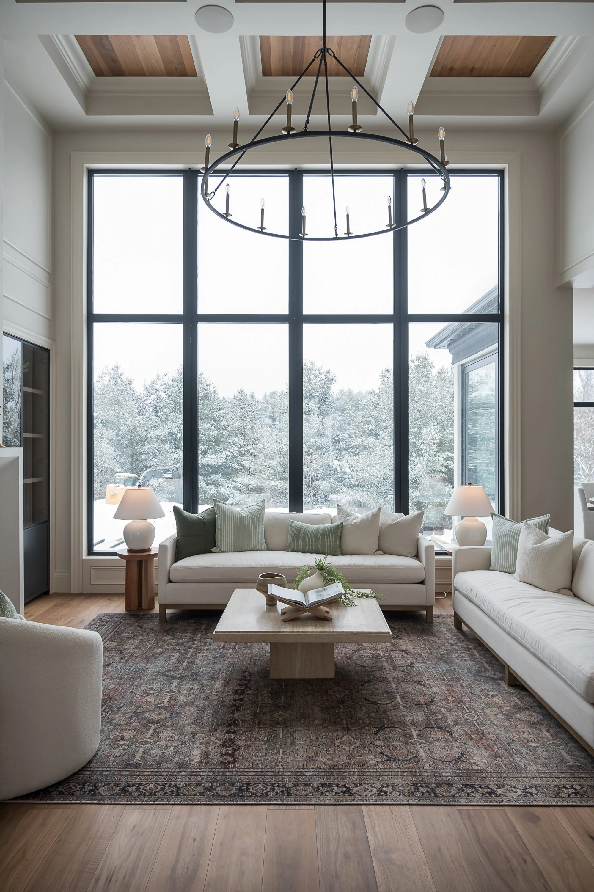Living room with floor-to-ceiling windows and seating layout interior design in Oakville Ontario by JT & Co Interiors