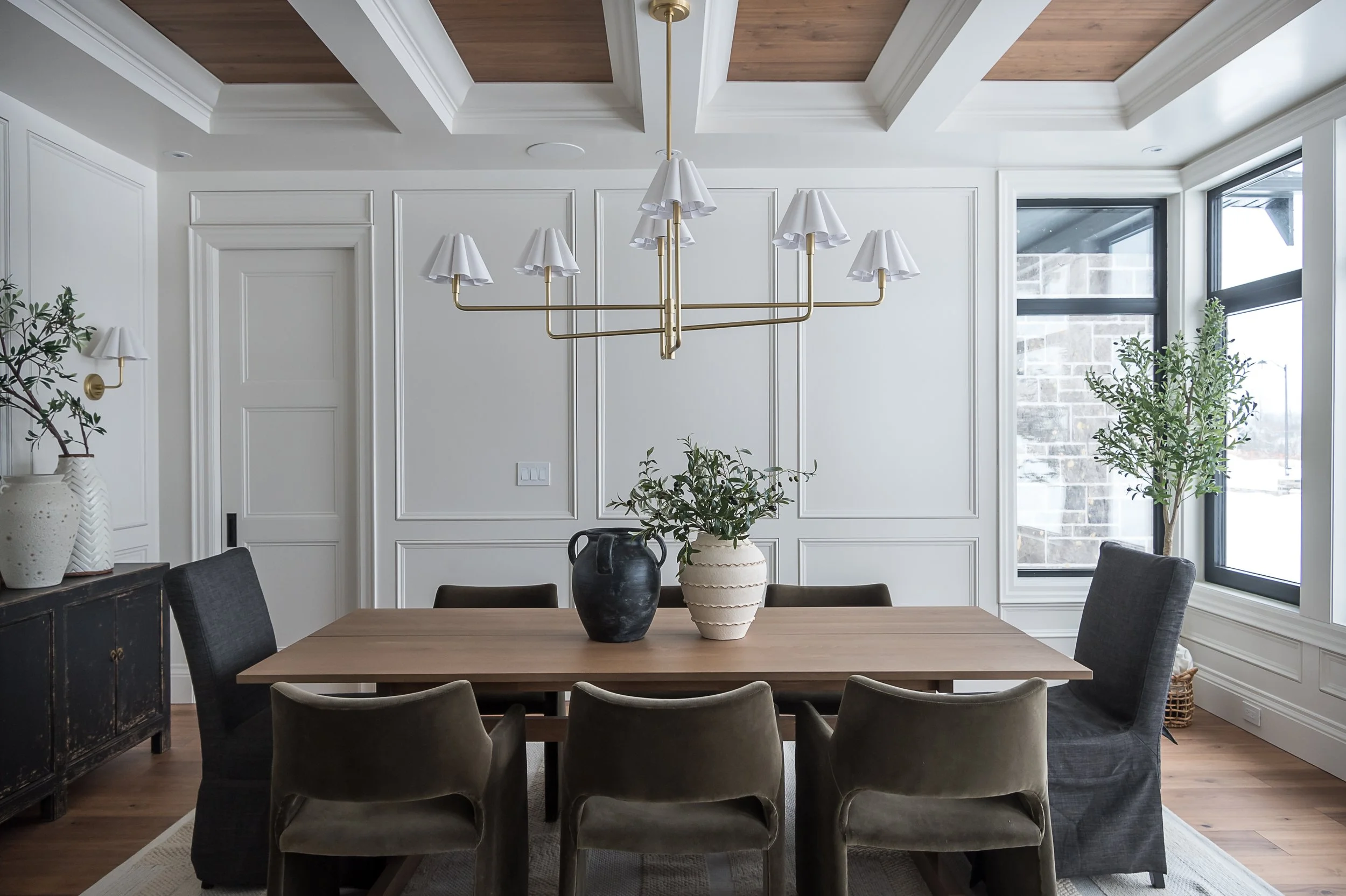 Dining room with coffered ceiling and brass chandelier interior design in Oakville Ontario by JT & Co Interiors